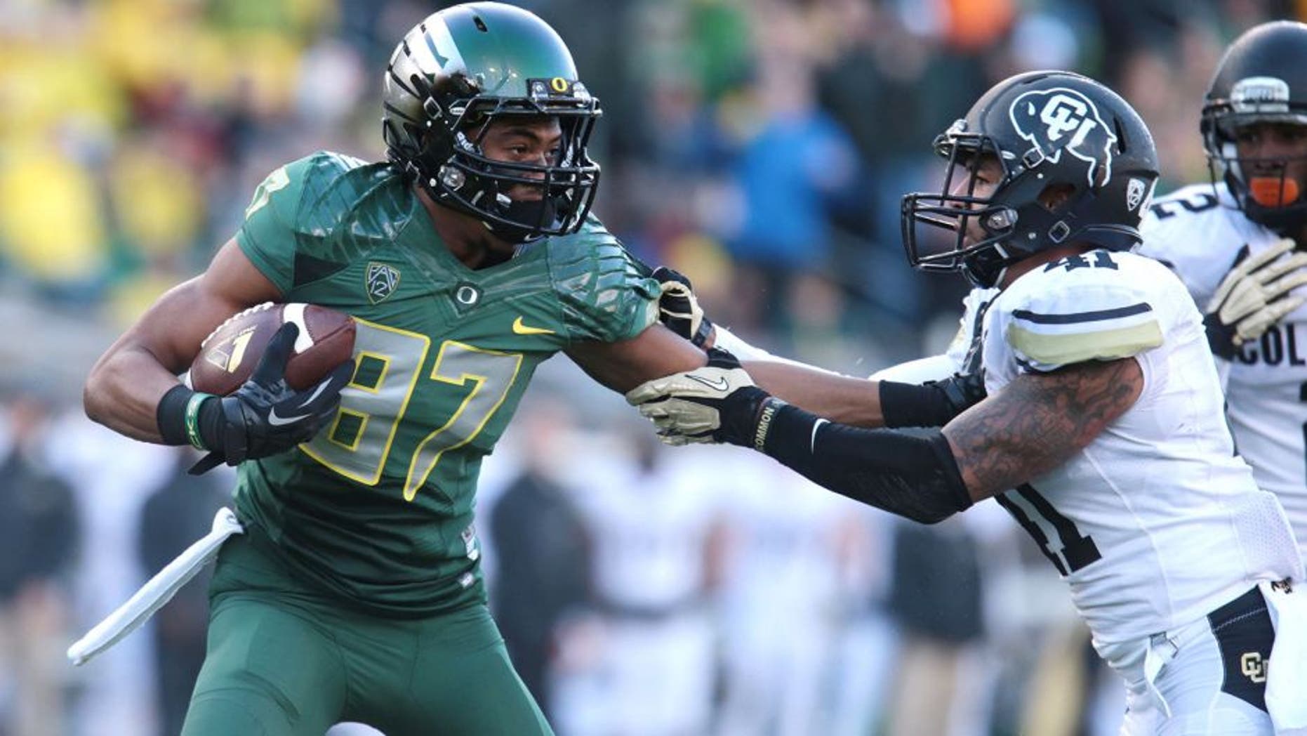 Nov 22, 2014; Eugene, OR, USA; Oregon Ducks wide receiver Darren Carrington (87) runs the ball against Colorado Buffaloes defensive back Terrel Smith (41) at Autzen Stadium. Mandatory Credit: Scott Olmos-USA TODAY Sports