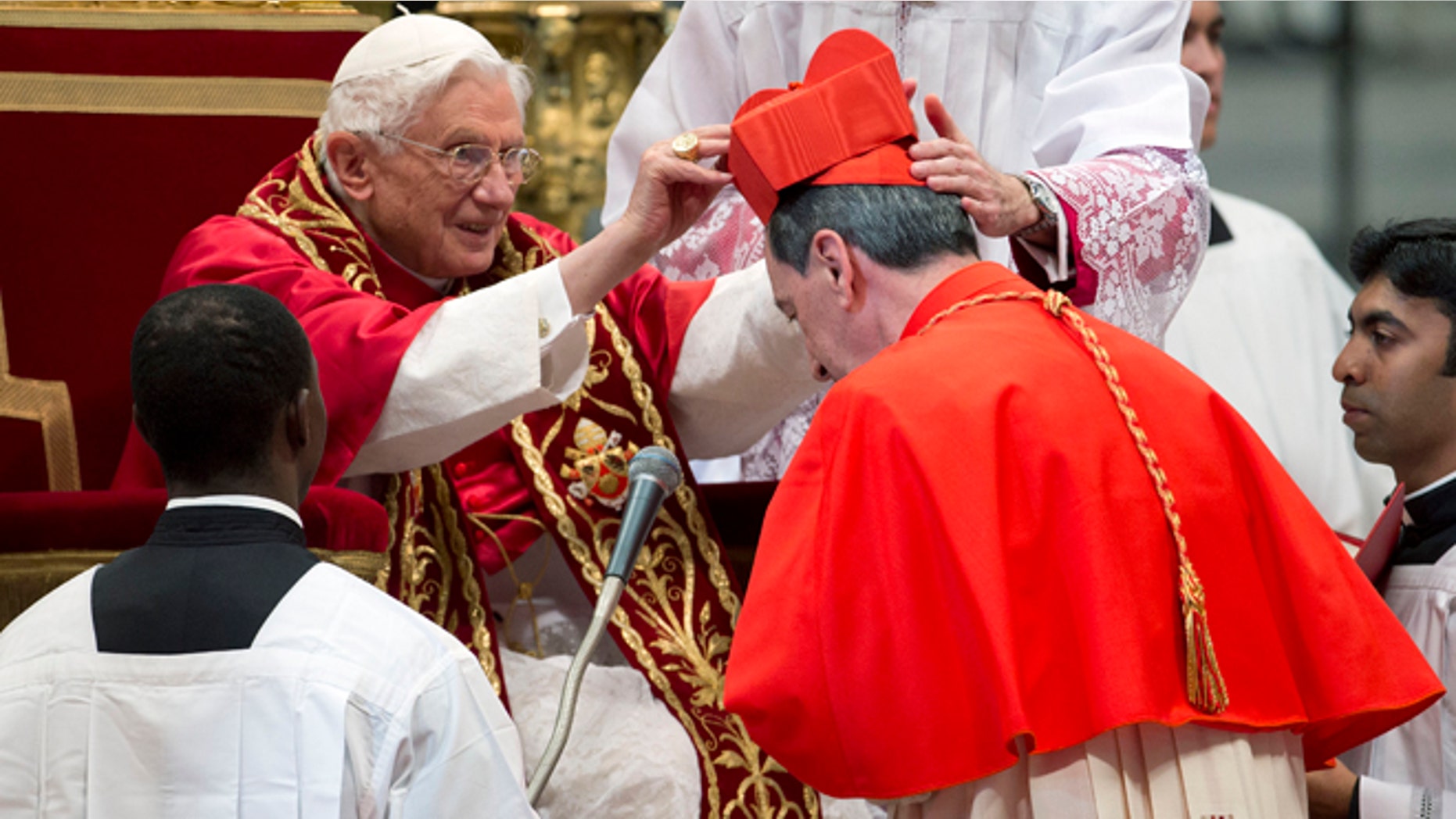Nov. 24, 2012: Newly elected Cardinal, Ruben Salazar Gomez of Colombia, right, receives the red three-cornered biretta hat from Pope Benedict XVI during a consistory inside the St. Peter's Basilica at the Vatican.