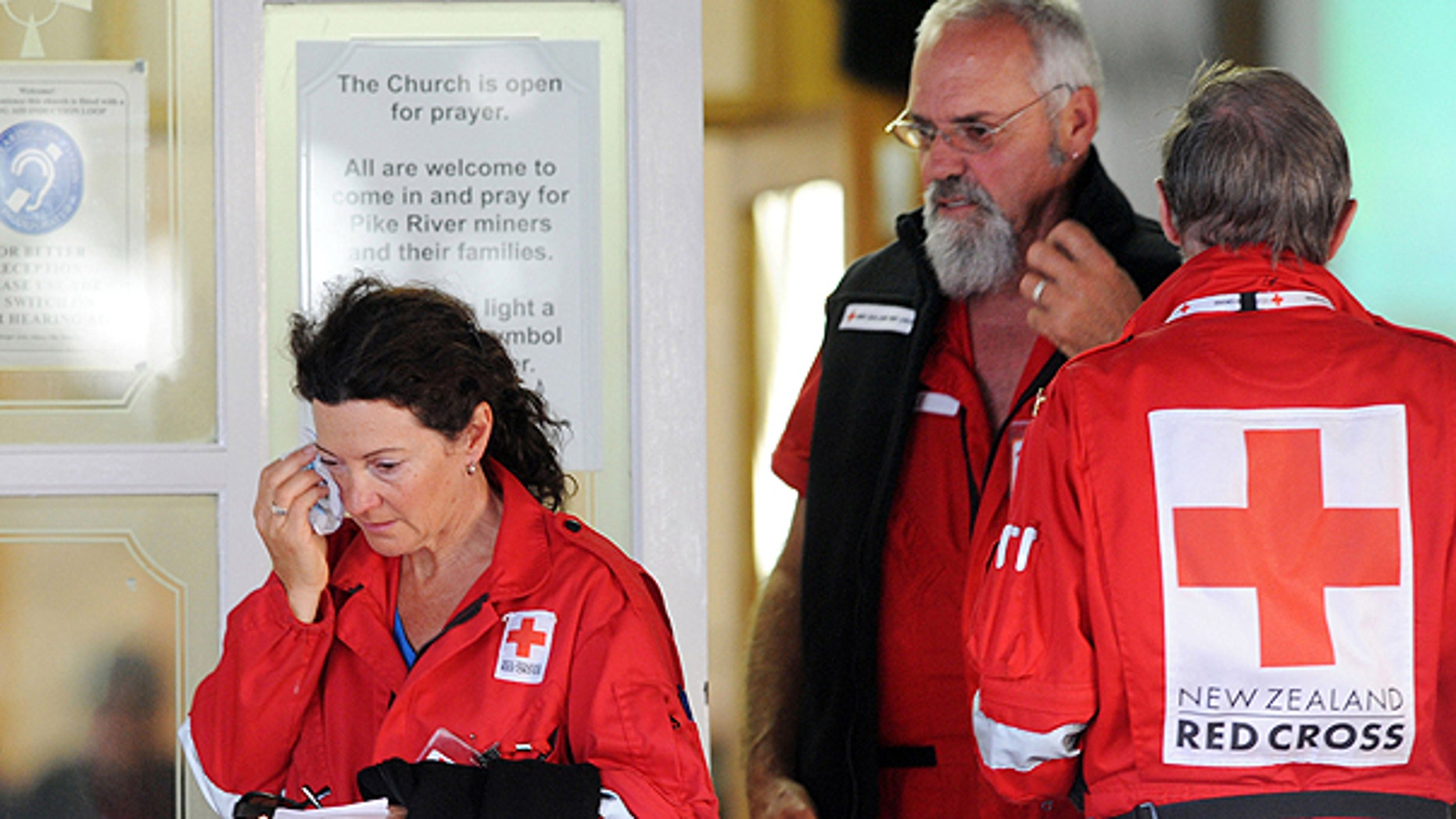 Nov. 24: Red Cross volunteers leave a candlelight vigil following a second explosion at the Pike River Coal Mines in Greymouth, New Zealand.