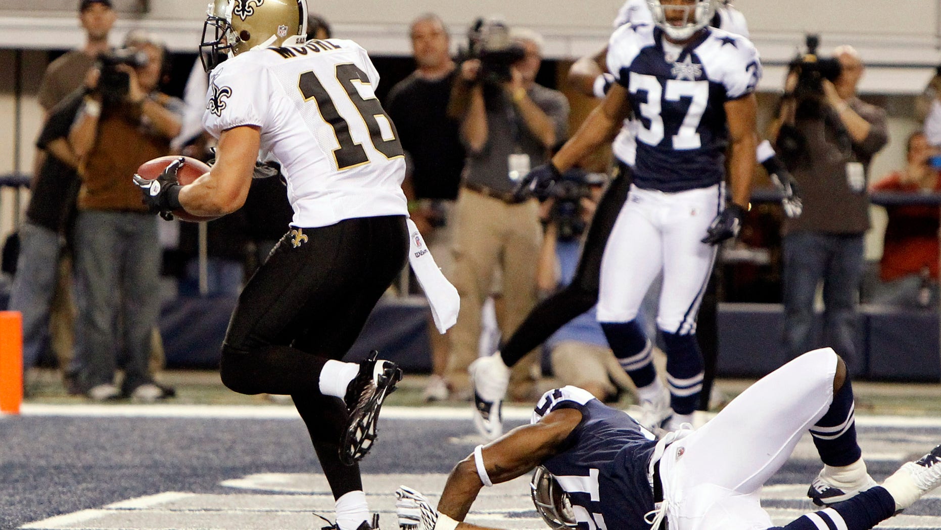 Nov. 25: New Orleans Saints wide receiver Lance Moore (16) scores the game-winning touchdown against Dallas Cowboys cornerback Mike Jenkins (21) as Bryan McCann (37) looks on during the fourth-quarter of the NFL football game in Arlington, Texas.