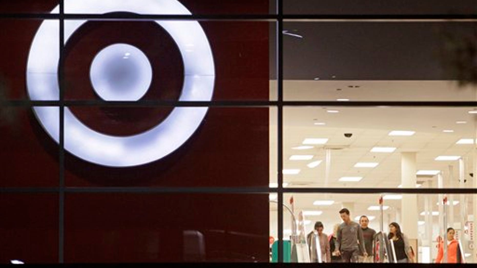 Nov. 16: Shoppers are seen leaving a Target store, in Atlanta. As retailers prepare for the crowds of shoppers on Black Friday with sharply reduced prices on everything from TVs to toys, they're also hoping for something else they couldn't count on last year: consumers springing for that deluxe high-end flat-panel TV or that big playset.