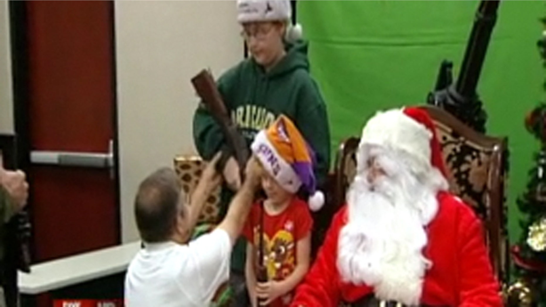 November 26, 2011: Children pose with Santa and guns at an Arizona gun club.