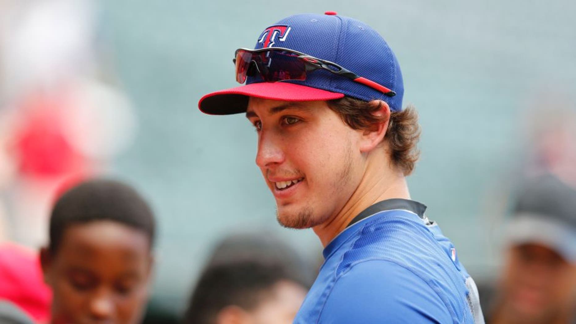 Jul 7, 2014; Arlington, TX, USA; Texas Rangers pitcher Derek Holland (45) signs autographs prior to the game against the Houston Astros at Global Life Park in Arlington. Mandatory Credit: Matthew Emmons-USA TODAY Sports