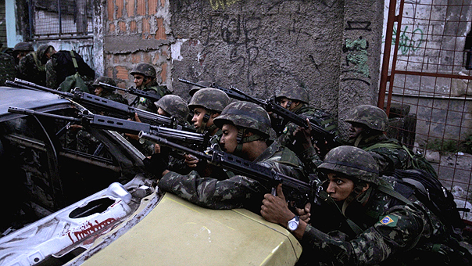 Nov. 27: Soldier aim their weapons during an operation against drug traffickers at the Complexo do Alemao slum in Rio de Janeiro, Brazil.