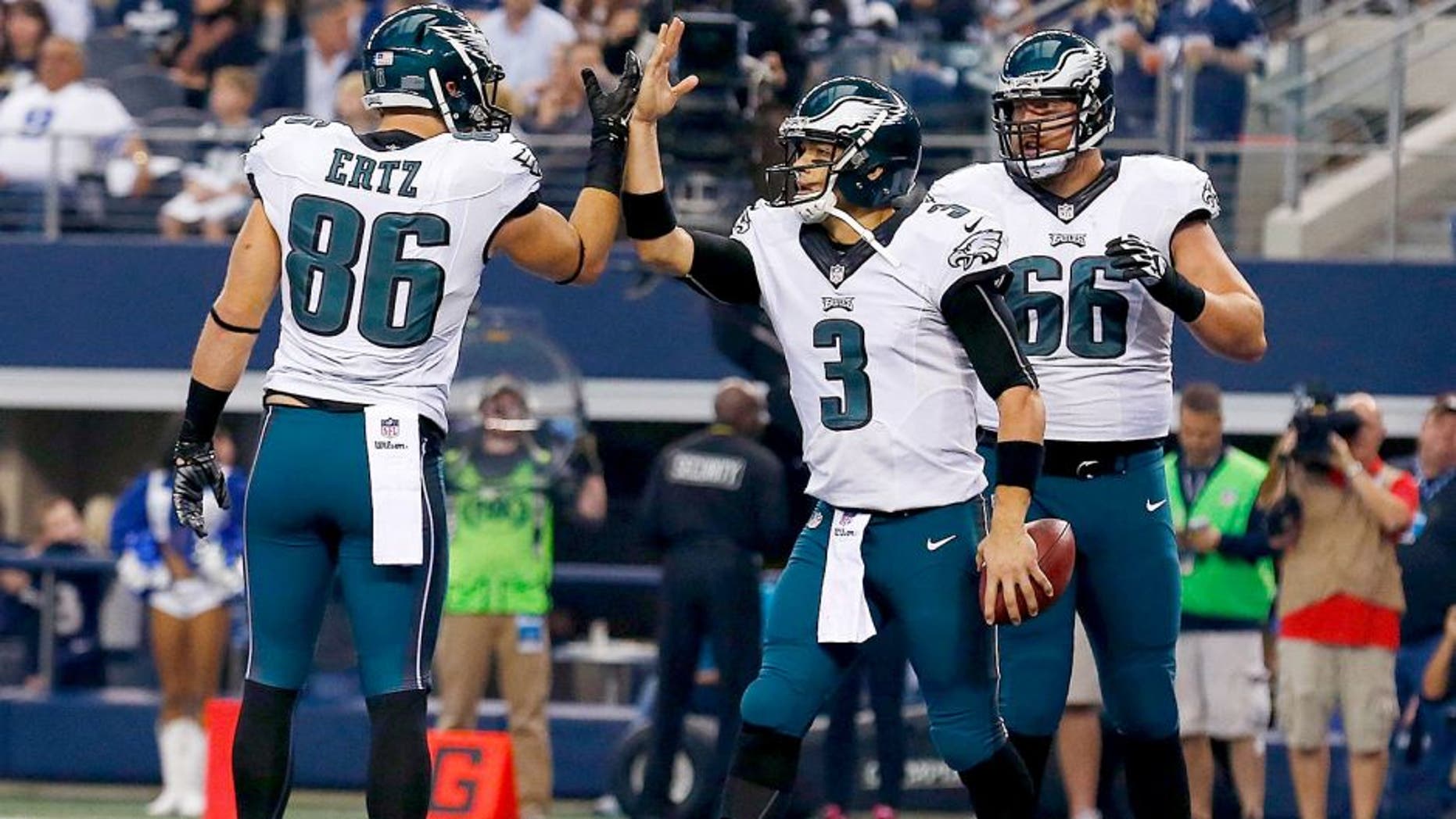 ARLINGTON, TX - NOVEMBER 27: Mark Sanchez #3 of the Philadelphia Eagles is congratulated by Zach Ertz #86 of the Philadelphia Eagles as Andrew Gardner #66 of the Philadelphia Eagles is near after he scored a touchdown against the Dallas Cowboys in the first half at AT&T Stadium on November 27, 2014 in Arlington, Texas. (Photo by Tom Pennington/Getty Images)