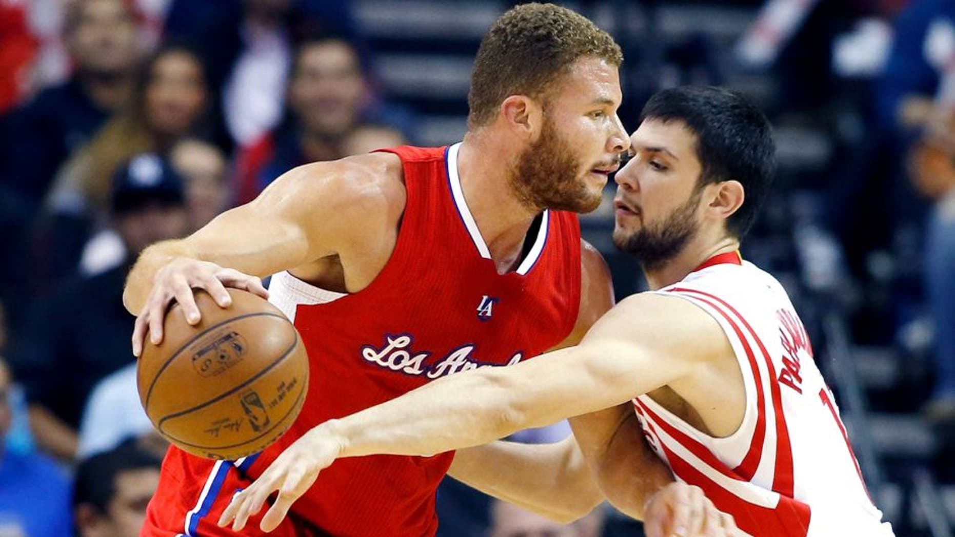 HOUSTON, TX - NOVEMBER 28: Blake Griffin #32 of the Los Angeles Clippers drives with the basketball against Kostas Papanikolaou #16 of the Houston Rockets during their game at the Toyota Center on November 28, 2014 in Houston, Texas. NOTE TO USER: User expressly acknowledges and agrees that, by downloading and/or using this photograph, user is consenting to the terms and conditions of the Getty Images License Agreement. (Photo by Scott Halleran/Getty Images)
