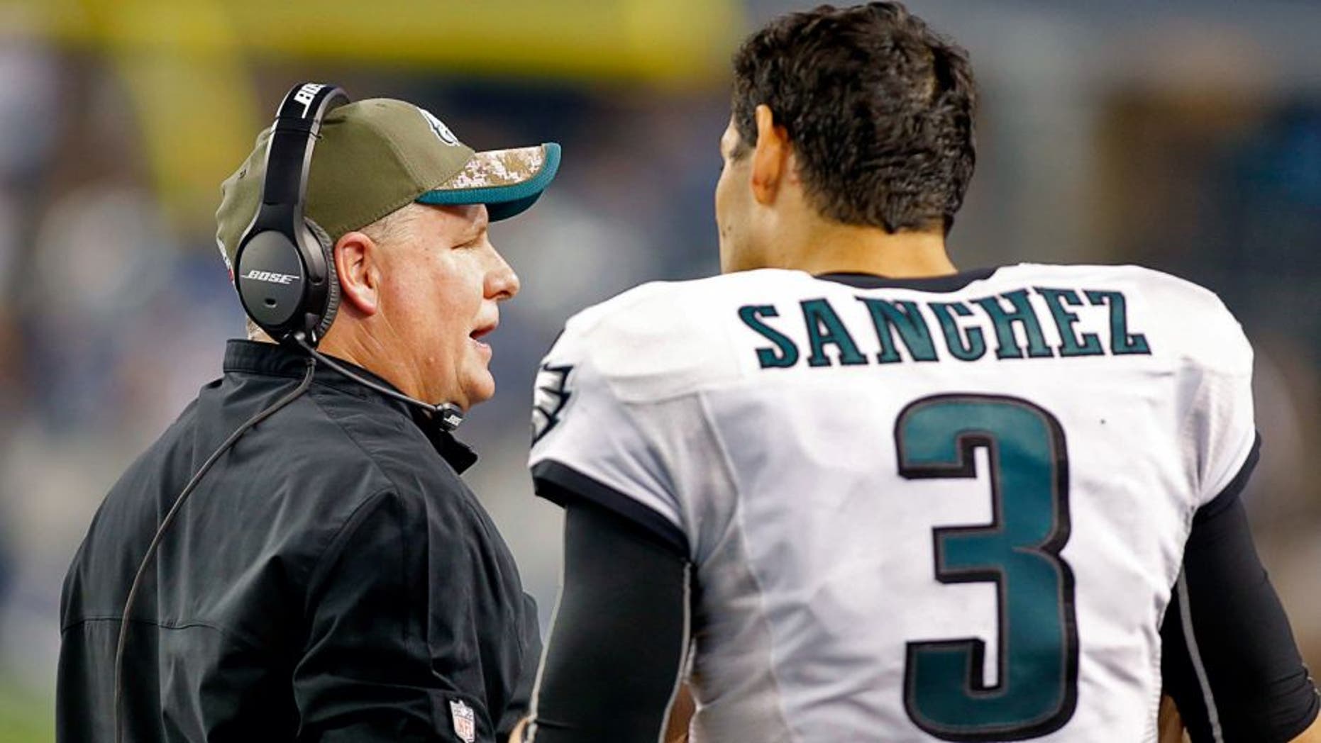 Nov 27, 2014; Arlington, TX, USA; Philadelphia Eagles head coach Chip Kelly talks with quarterback Mark Sanchez (3) on the sidelines during the game against the Dallas Cowboys at AT&T Stadium. Philadelphia beat Dallas 33-10. Mandatory Credit: Tim Heitman-USA TODAY Sports