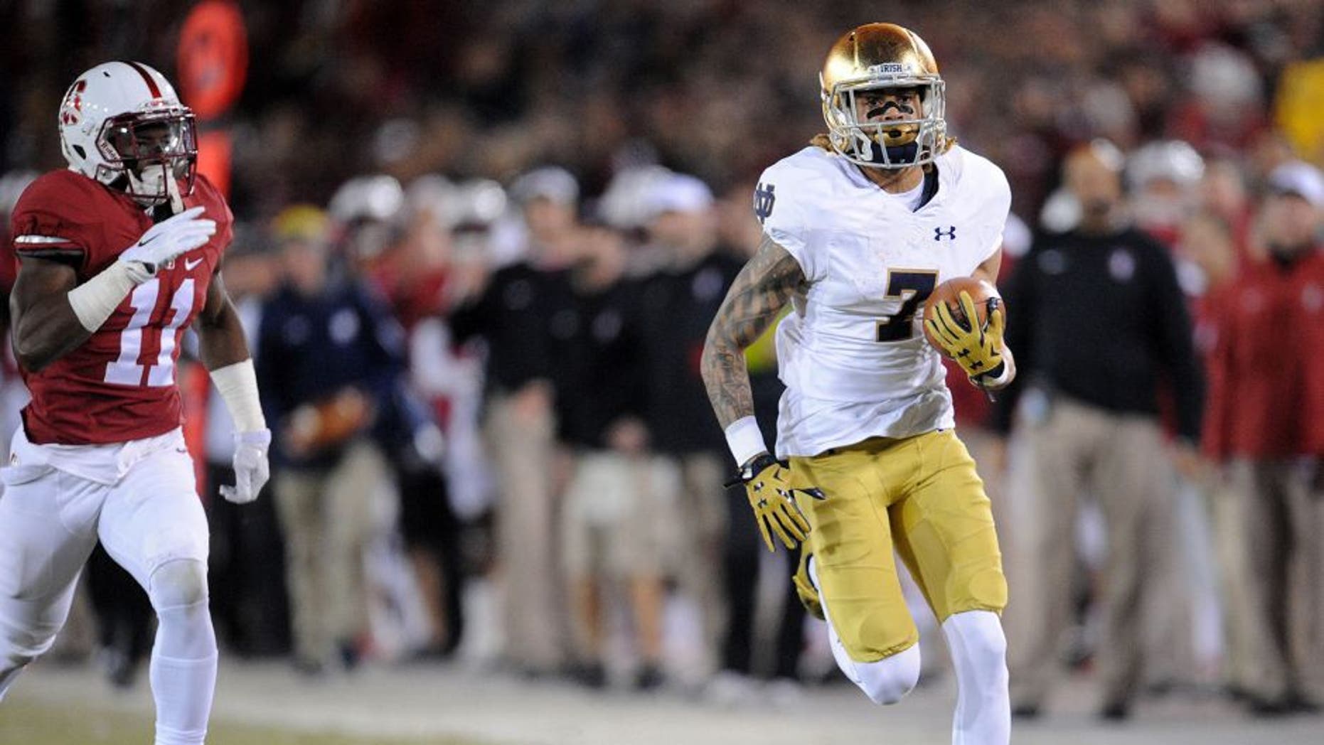 November 28, 2015; Stanford, CA, USA; Notre Dame Fighting Irish wide receiver Will Fuller catches a pass and runs for a touchdown ahead of Stanford Cardinal cornerback Terrence Alexander (11) during the first half at Stanford Stadium. Mandatory Credit: Gary A. Vasquez-USA TODAY Sports