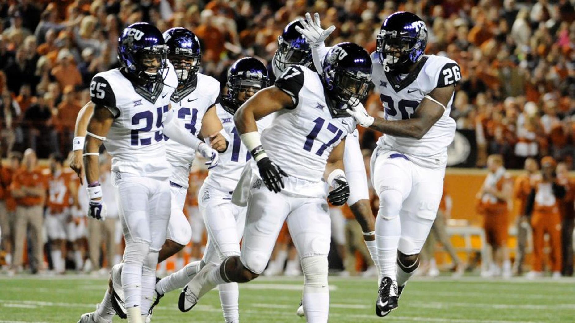 Nov 27, 2014; Austin, TX, USA; TCU Horned Frogs safety Sam Carter (17) celebrates with teammates after intercepting a pass against the Texas Longhorns during the game at Darrell K Royal-Texas Memorial Stadium. Mandatory Credit: Brendan Maloney-USA TODAY Sports