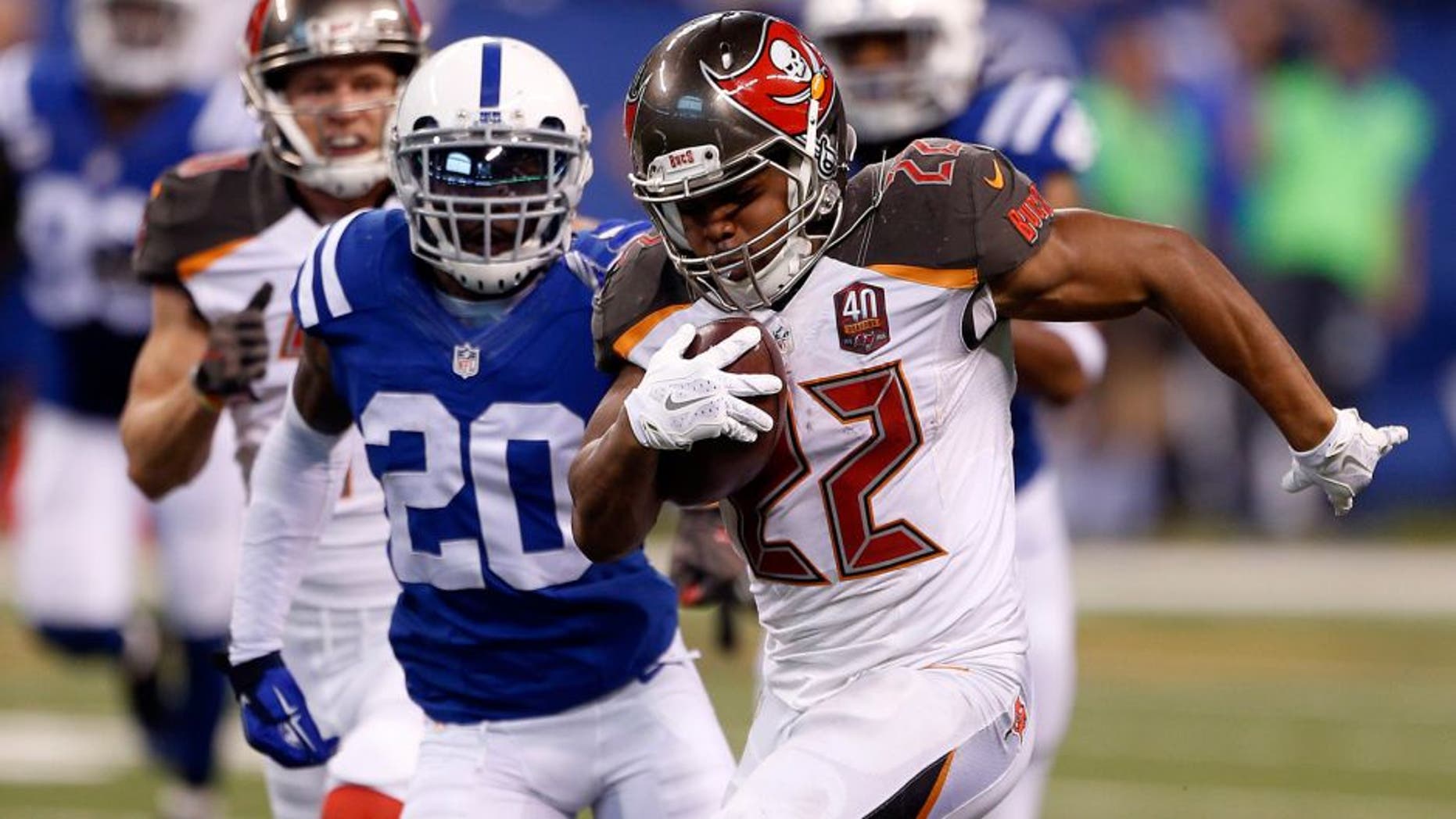 Nov 29, 2015; Indianapolis, IN, USA; Tampa Bay Buccaneers running back Doug Martin (22) is tackled by Indianapolis Colts cornerback Darius Butler (20) at Lucas Oil Stadium. Mandatory Credit: Brian Spurlock-USA TODAY Sports