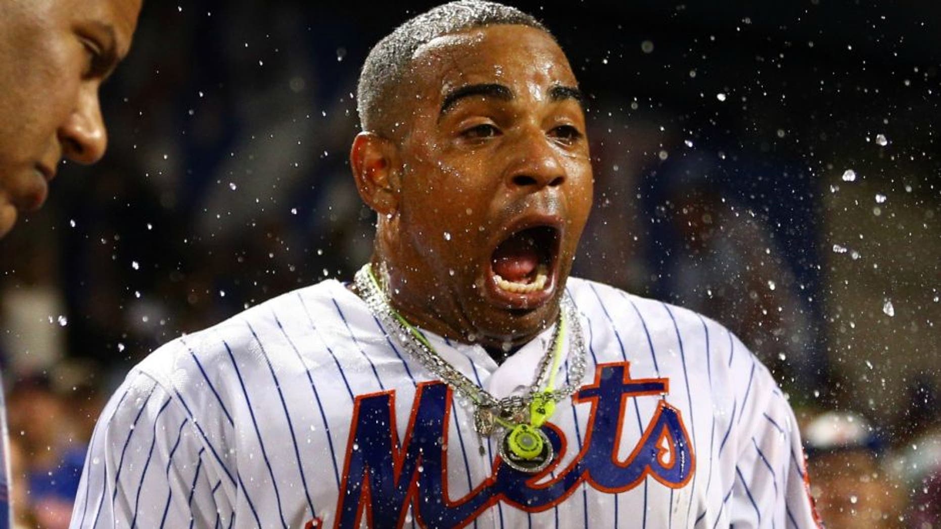 Aug 29, 2016; New York City, NY, USA; New York Mets left fielder Yoenis Cespedes (52) reacts after being doused by Mets second baseman Wilmer Flores (not pictured) during his post game interview after hitting a walk off solo home run against the Miami Marlins during the tenth inning at Citi Field. Mandatory Credit: Brad Penner-USA TODAY Sports