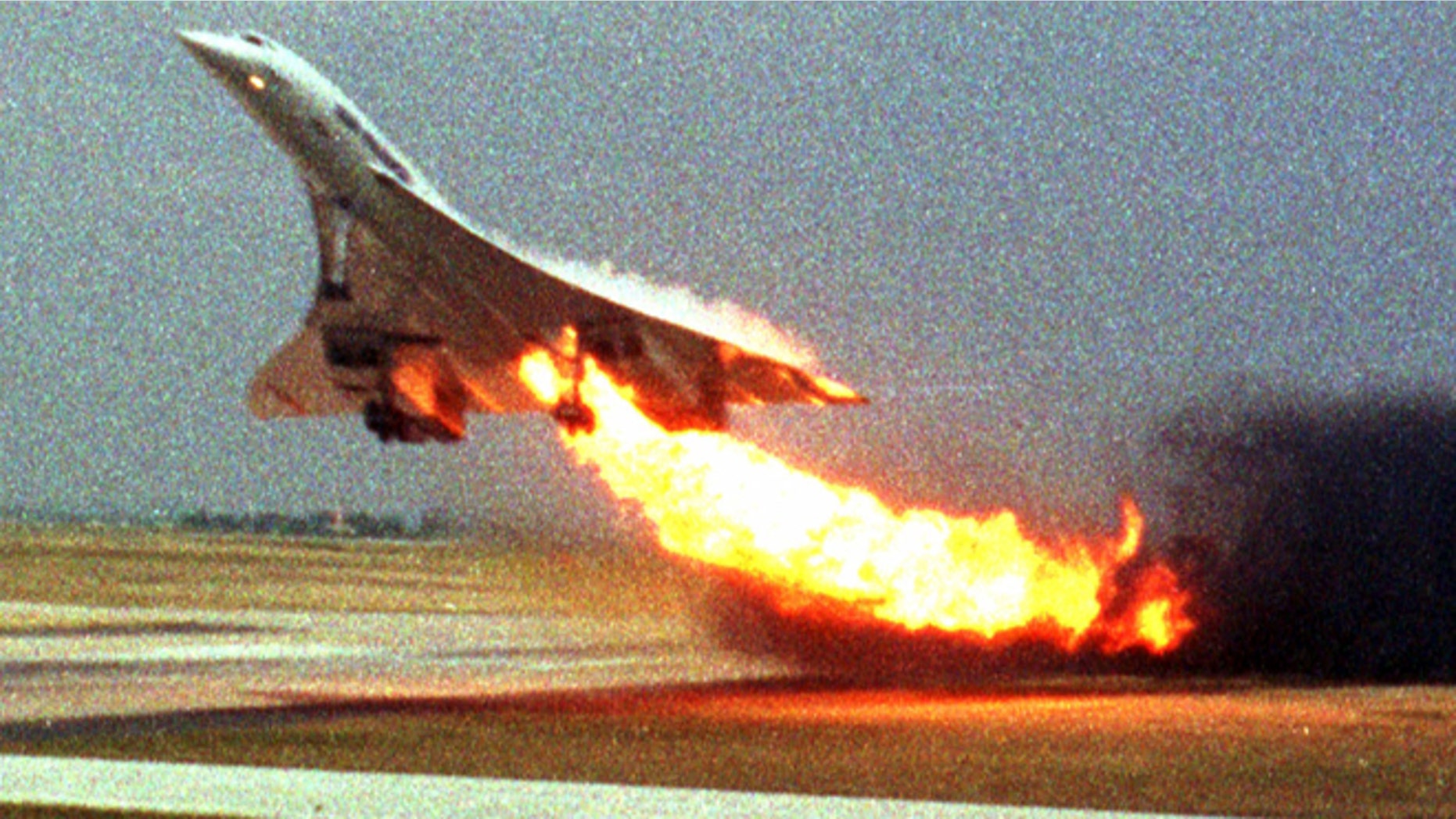 FILE - In this July 25, 2000, file photo, Air France Concorde flight 4590 takes off with fire trailing from its engine on the left wing from Charles de Gaulle airport in Paris.