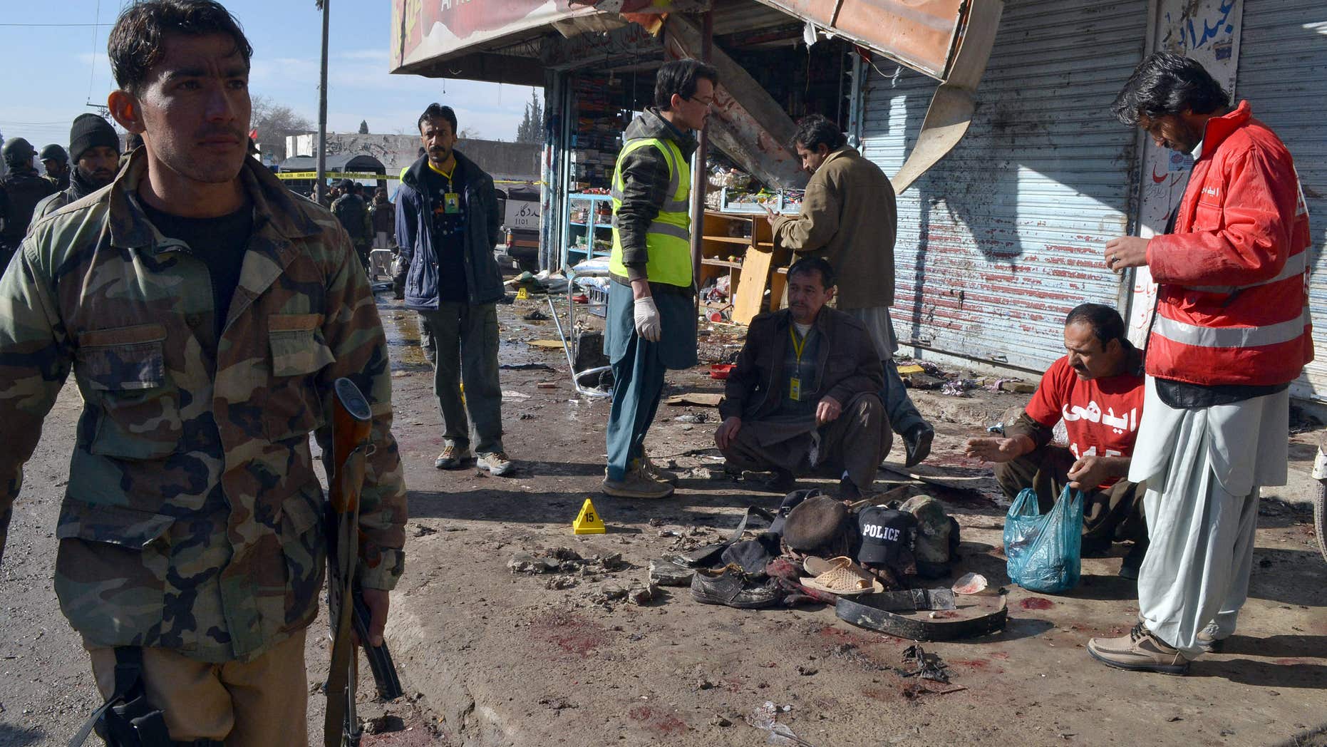Jan. 13, 2016: Pakistani police officer and rescue workers gather at the site of suicide bombing in Quetta, Pakistan