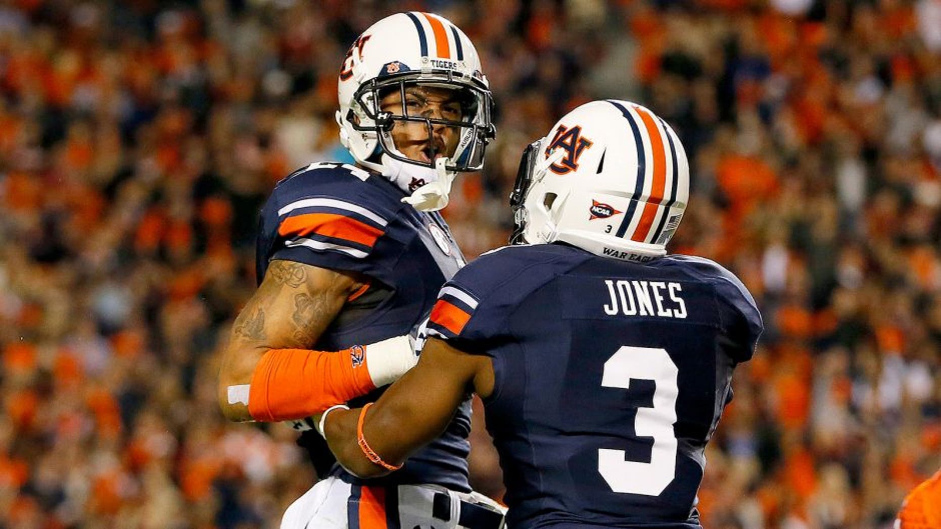 AUBURN, AL - NOVEMBER 30: Ryan Smith #24 of the Auburn Tigers yells to an official as he and Jonathan Jones #3 react after Smith recovered a blocked punt in the fourth quarter against the Alabama Crimson Tide at Jordan-Hare Stadium on November 30, 2013 in Auburn, Alabama. (Photo by Kevin C. Cox/Getty Images)