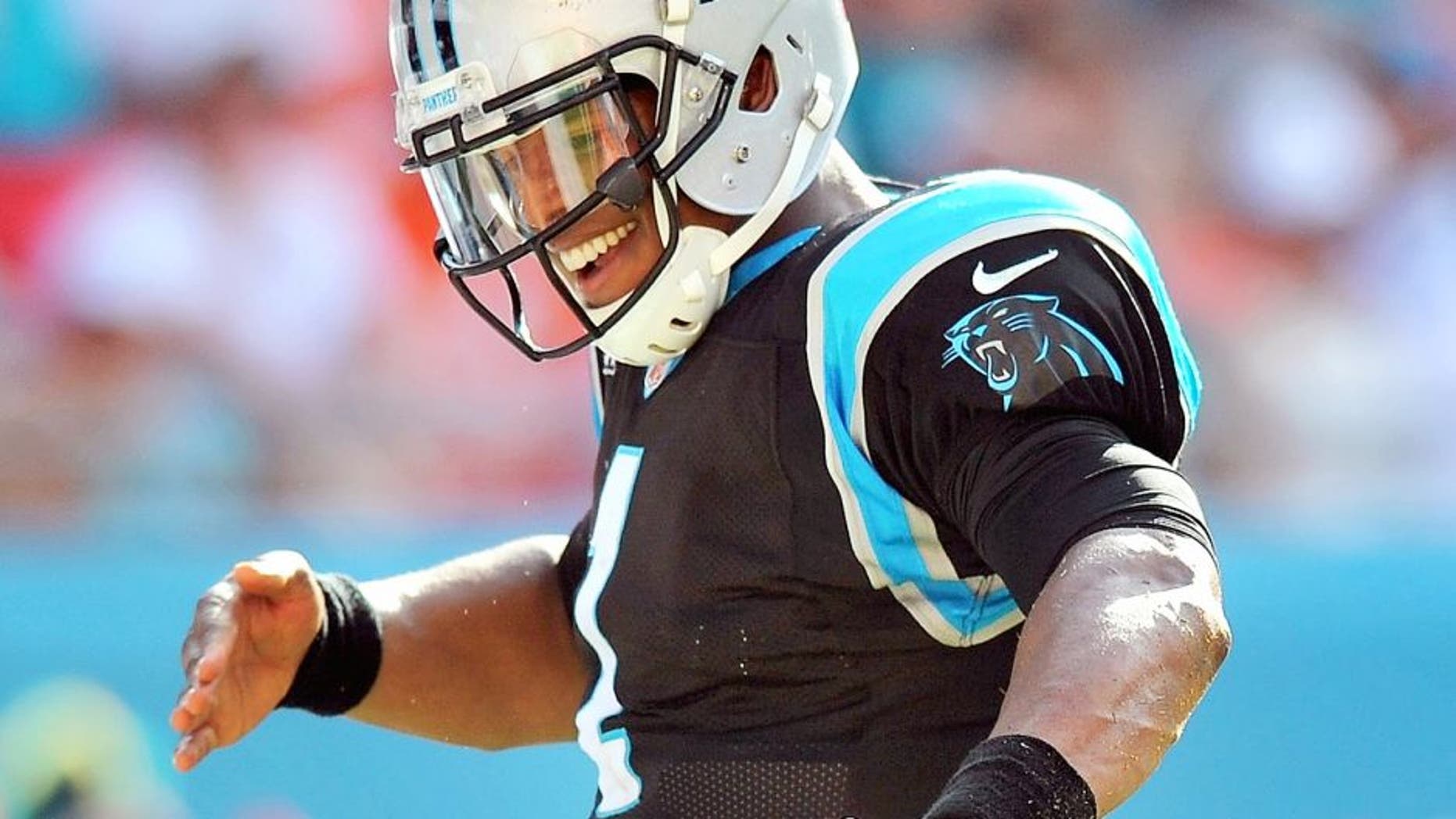 Nov 24, 2013; Miami Gardens, FL, USA; Carolina Panthers quarterback Cam Newton (1) celebrates after scoring a touchdown during the second half against the Miami Dolphins at Sun Life Stadium. The Panthers won 20-16. Mandatory Credit: Steve Mitchell-USA TODAY Sports