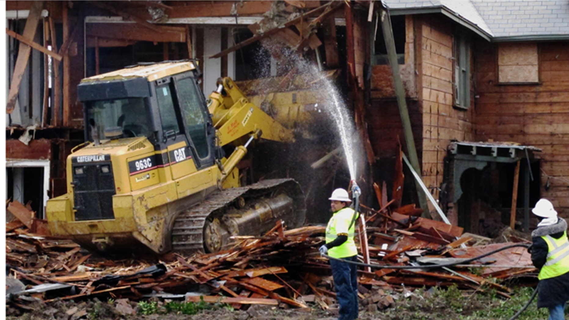 Jan. 14, 2013: A bulldozer is used to demolish a two-story apartment building in Dallas, Texas where Lee Harvey Oswald briefly lived before assassinating President John F. Kennedy.