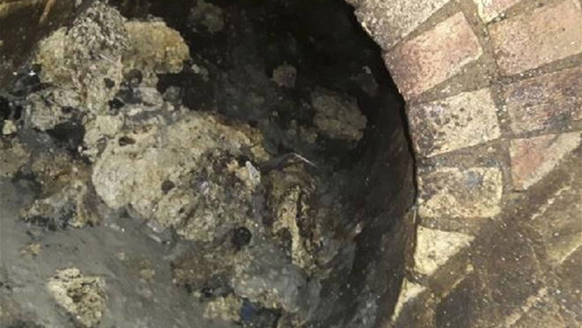 In this undated handout photo issued by Thames Water on Sept. 12, 2017, a view of part of a fatberg is seen inside a sewer in Whitechapel, London.