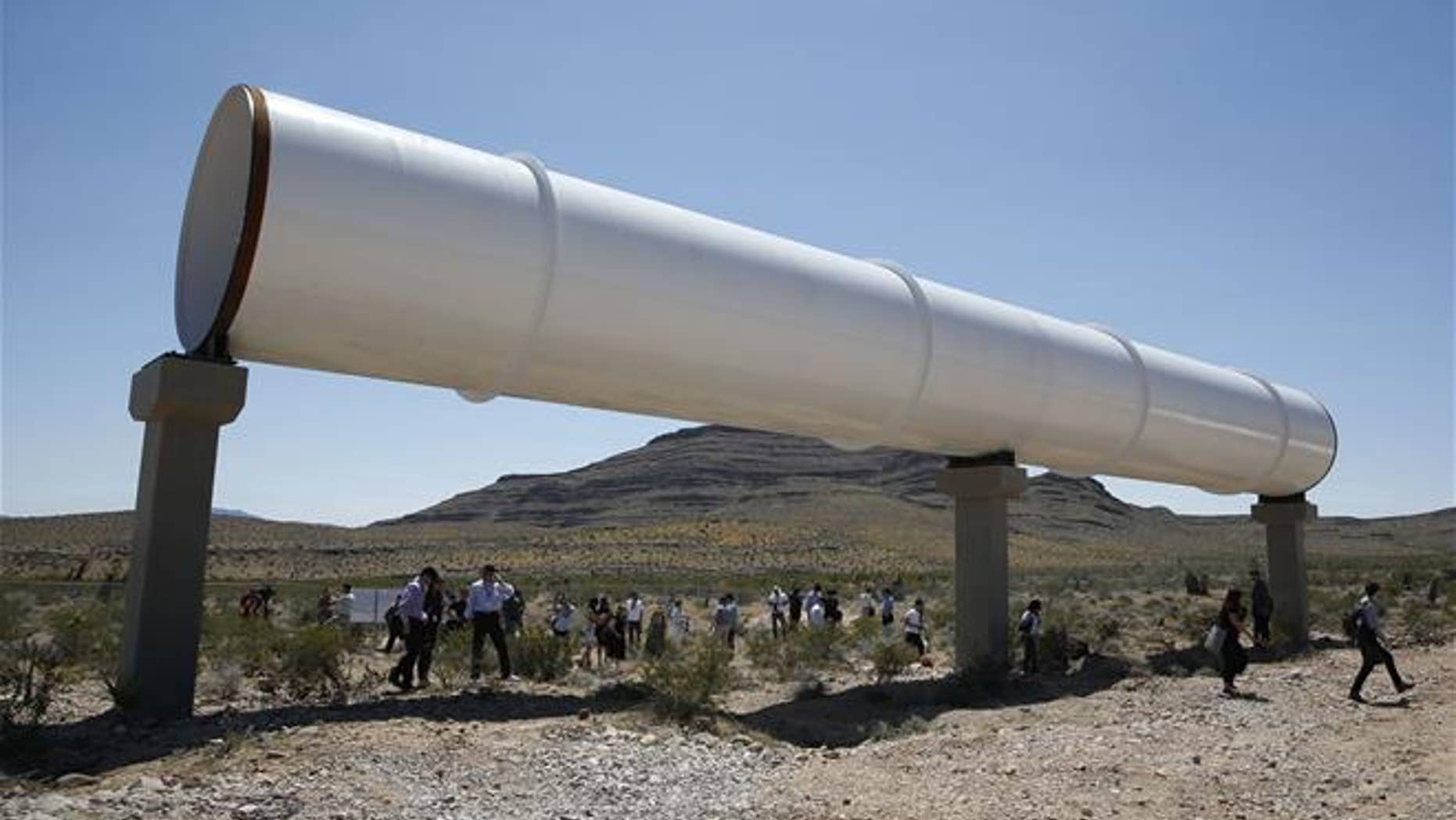 People tour the site after a test of a Hyperloop One propulsion system in North Las Vegas, Nev., in 2016.