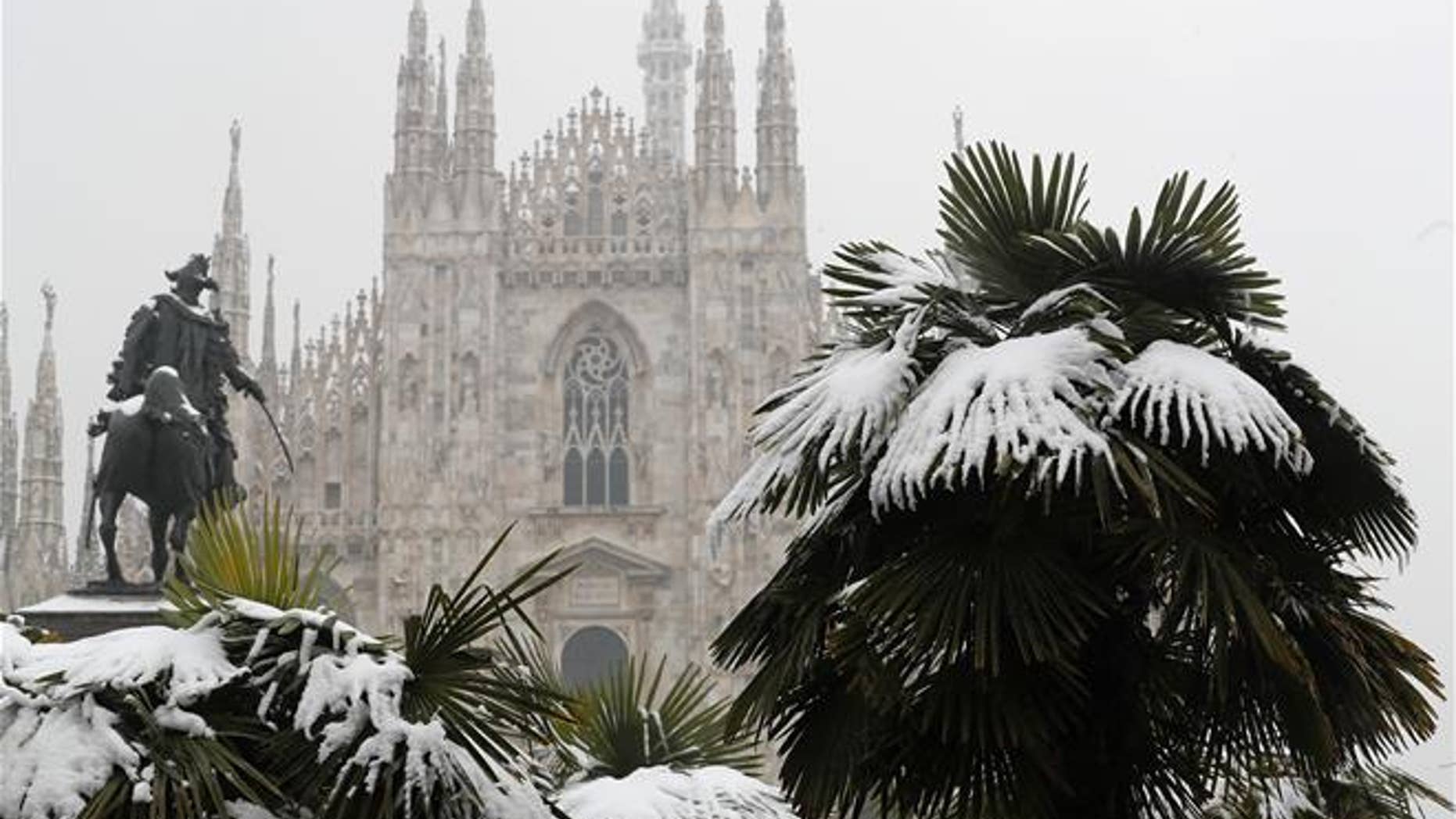 Palm trees are dusted in snow in front of Milan's Gothic Cathedral, Italy, on March 2, 2018.