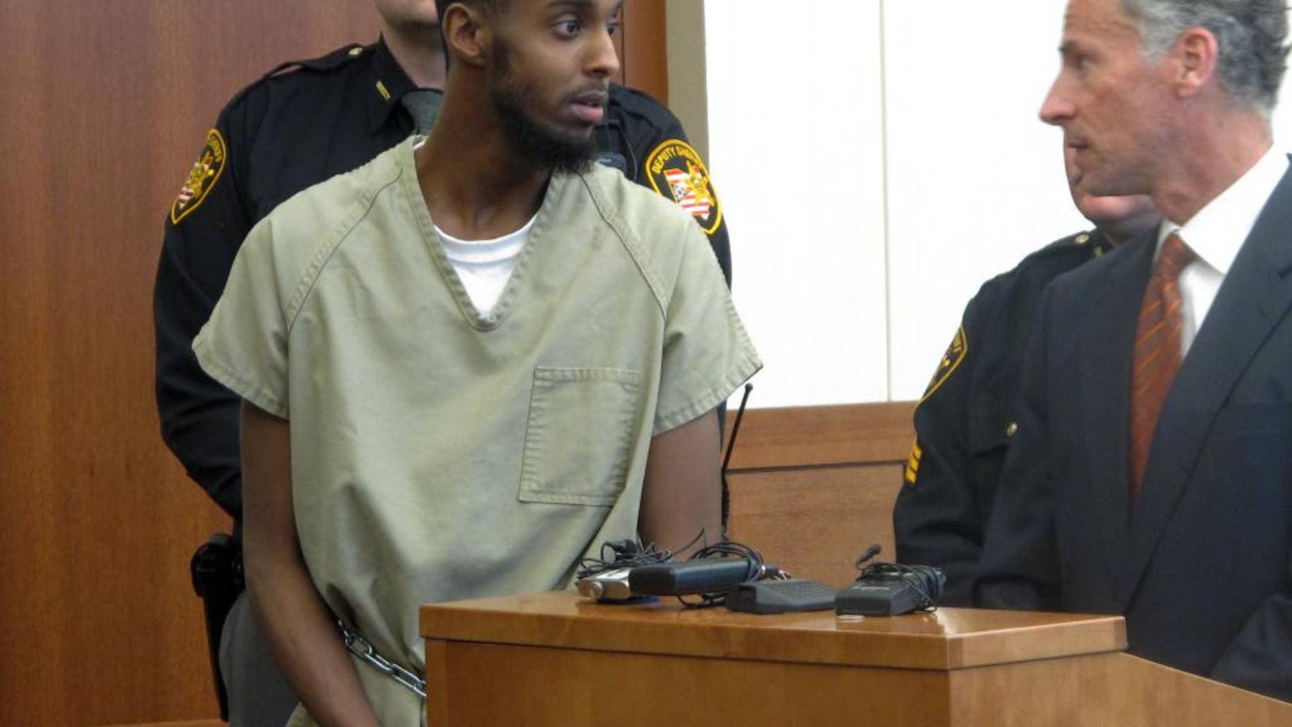 FILE - In this Feb. 25, 2015 file photo, Abdirahman Sheik Mohamud, left, speaks with his defense attorney, Sam Shamansky, during a hearing to set bond on charges of money laundering and providing support for terrorism in Columbus, Ohio. A Thursday, April 16 indictment says Mohamud left the country a year ago to train and fight with terrorists in Syria. The indictment says Mohamud, who was arrested in Columbus earlier this year, weighed which extremist group in Syria was more effective before his travels. (AP Photo/Andrew Welsh-Huggins)