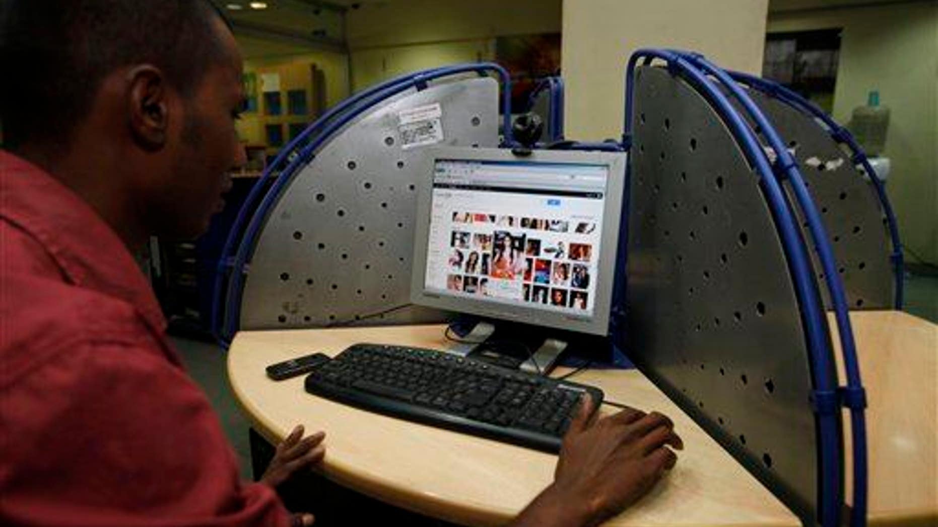 An Indian man surfs a Google page at an internet cafe in Hyderabad, India, Saturday, Jan. 14, 2012.