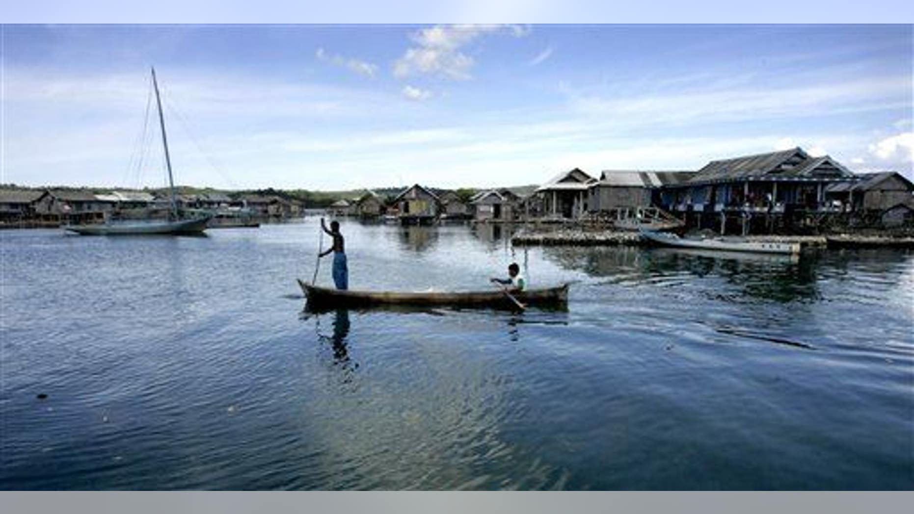 Men and women of the Bajau tribe row a boat at a fishing village on Kaledupa island, Southeast Sulawesi, Indonesia.