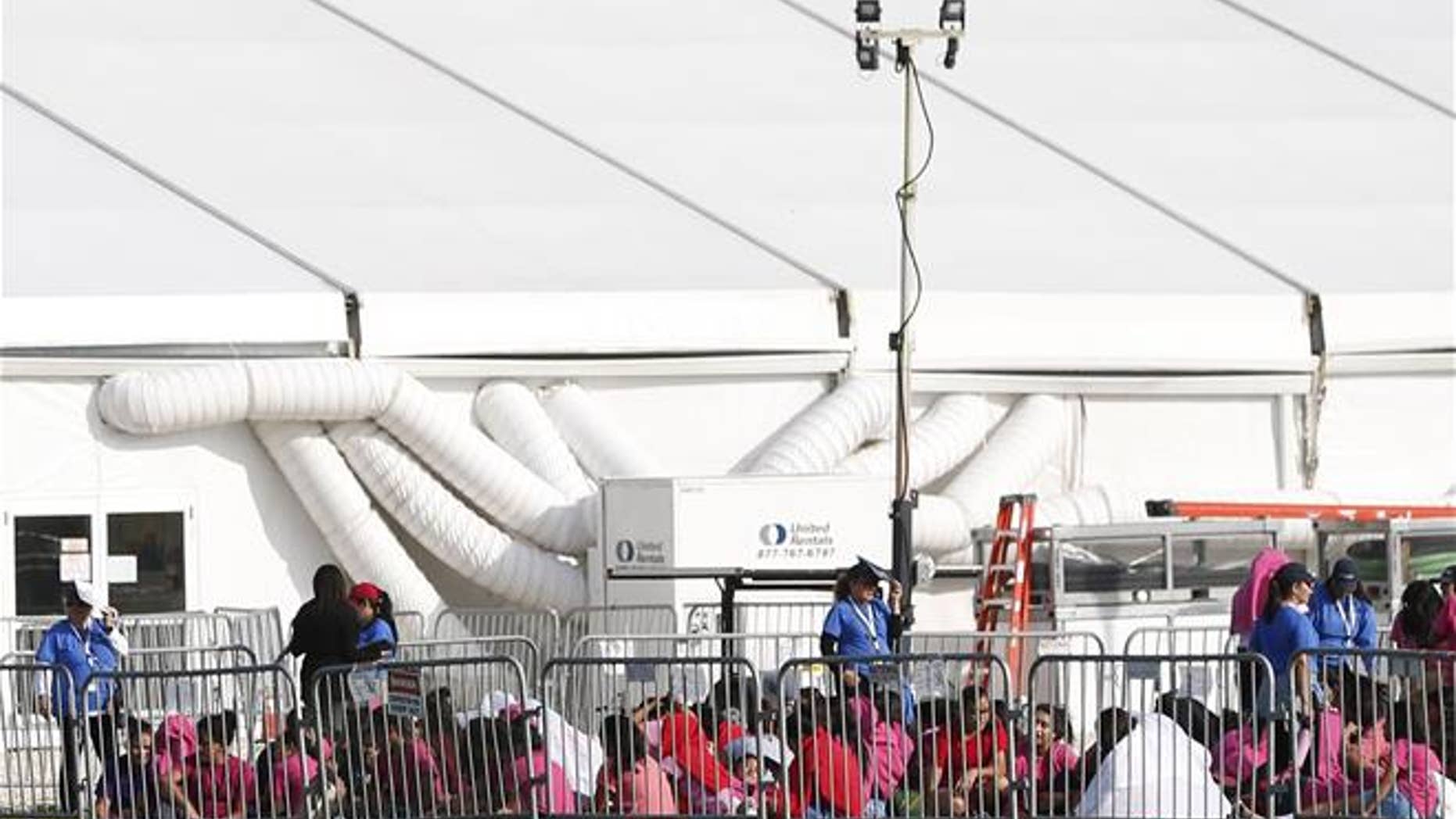 Immigrant children are shown outside a former Job Corps site that now houses them, Monday, June 18, 2018, in Homestead, Fla. It is not known if the children crossed the border as unaccompanied minors or were separated from family members.