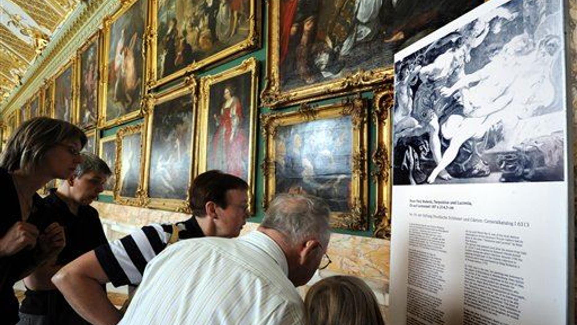 Visitors look at a photo of a missing painting by Peter Paul Rubens entitled "Tarquinius and Lucretia" in the Gallery of Sanssouci in Potsdam, Germany, in 2008. A different Rubens has now surfaced.