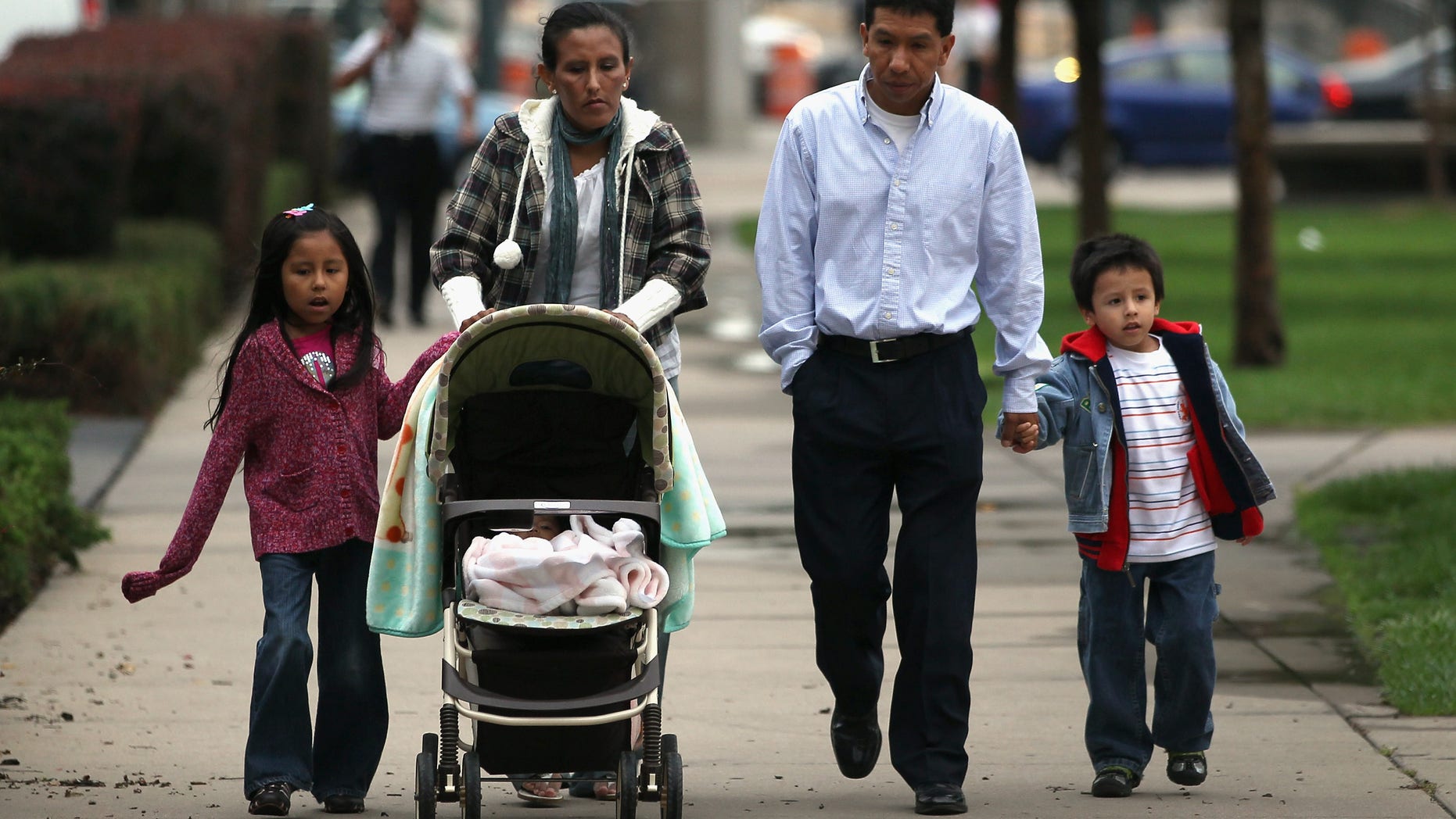 DENVER, CO - JULY 13: Undocumented Mexican immigrant Jeanette Vizguerra (L), her husband Salvador and their children Luna, 7, and Roberto, 5, walk to her immigration hearing in federal court on July 13, 2011 in Denver, Colorado. At the hearing, the court said it would not release it's verdict on her possible deportation until October, leaving her and her family in continued uncertainty. Vizguerra is a mother of four children, three of whom were born in the U.S. as American citizens. If Vizguerra is deported back to Mexico, she says her husband and children will stay on in the United States. Just one of millions of undocumented immigrants living in the U.S., Vizguerra first came to Colorado from Mexico City with her husband and first child 14 years before. Now an activist for the immigration advocate group Rights For All People, she also owns a janitorial service and says she has always paid state and federal taxes on her income. Some two years ago she was stopped by a traffic policemen for driving with expired tags and taken to jail when she could not prove her legal immigration status. Out on bail during court proceedings, she now faces the real possibility that she will be deported to Mexico and separated from her family in the United States. (Photo by John Moore/Getty Images)