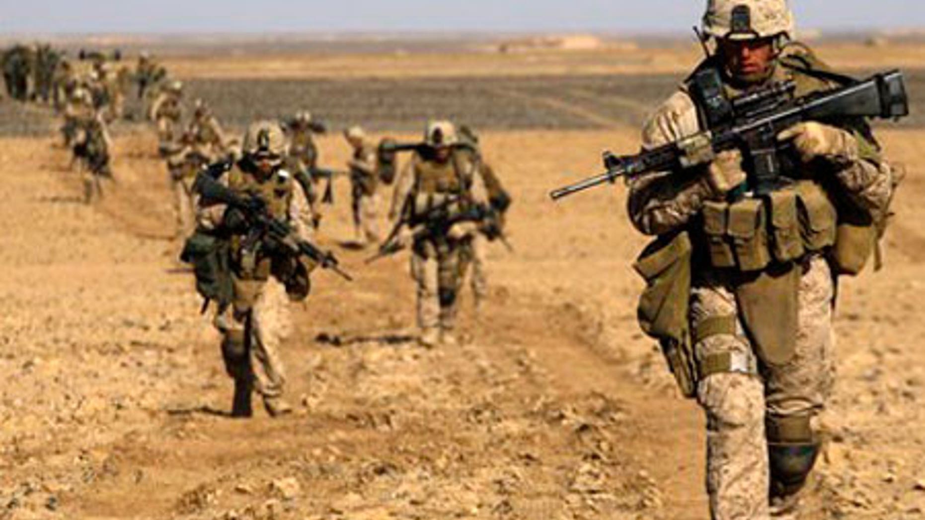 Feb. 13: U.S. Marines from 3rd Battalion, 6th Marine Regiment walk in a column as they enter Marjah in Afghanistan's Helmand province.