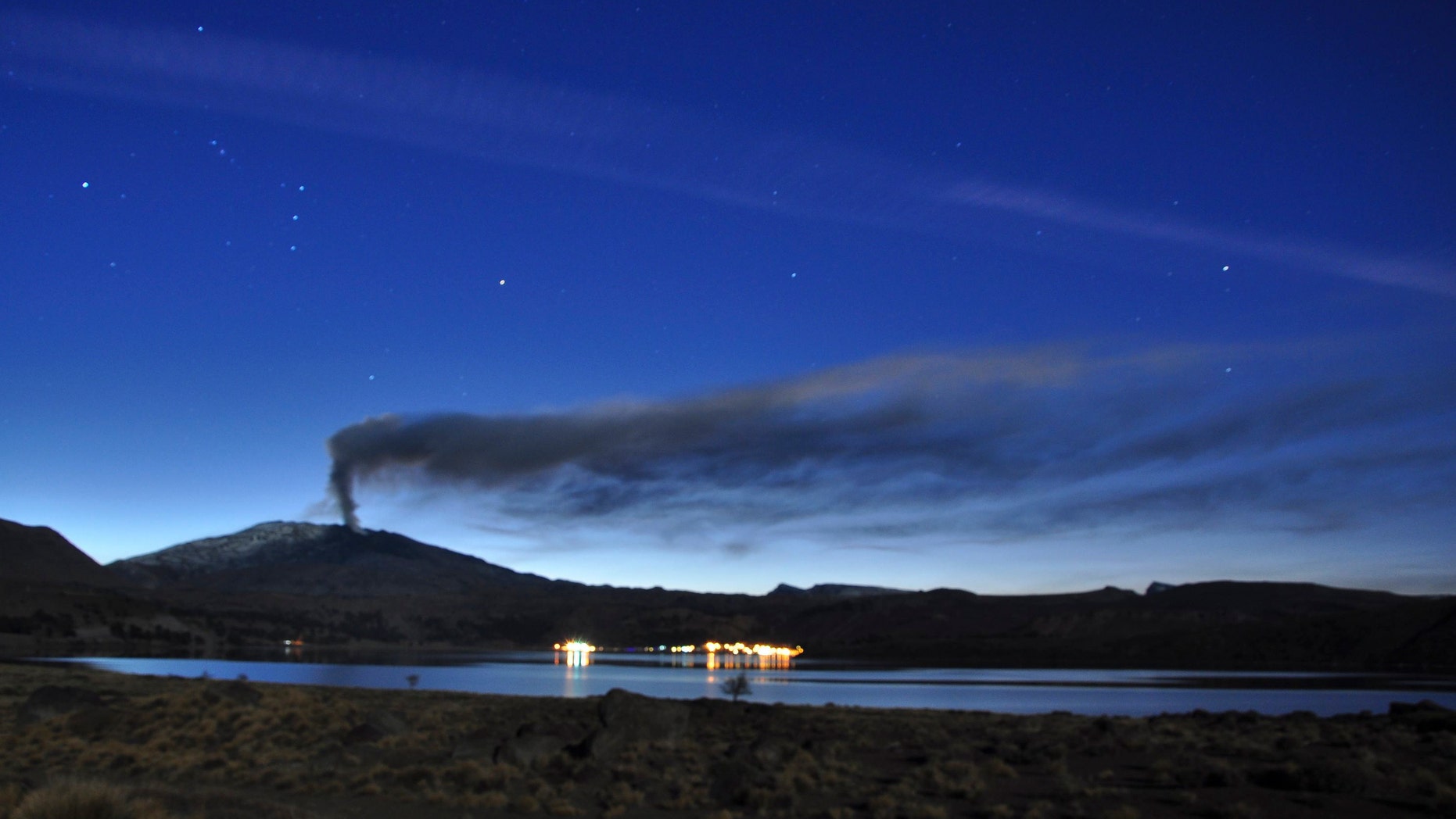 This photo released by the Government of Neuquen, Monday, May 27, 2013, shows a plume of ash and smoke rise from the Copahue volcano, as seen from Caviahue, in the Argentine province of Neuquen, Friday, May 24, 2013. Chile has issued a red alert for the Copahue volcano on the border with Argentina that has become increasingly active. The nearly 10,000-foot (2,965-meter) volcano sits in the Andes cordillera, straddling the border with Argentina's Neuquen province. (AP Photo/Government of Neuquen, Tony Huglich)