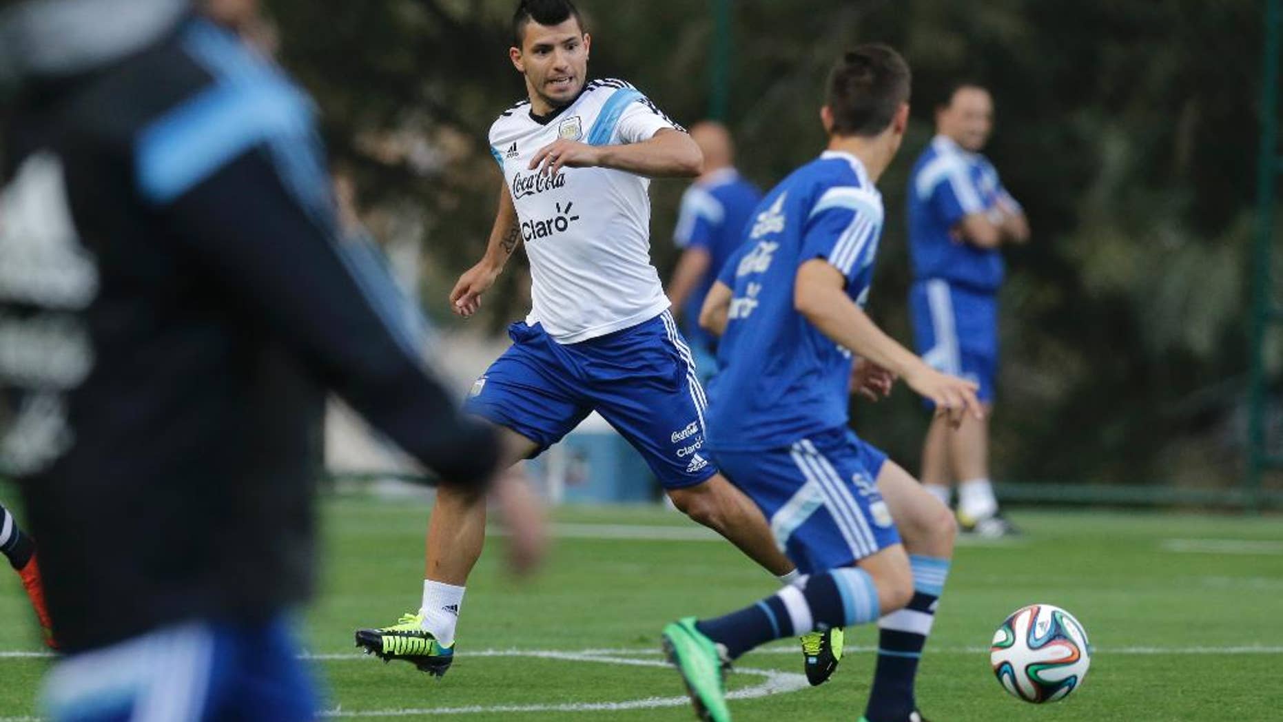 Argentina's Sergio Aguero, center, runs for the ball during a training session in Vespesiano, near Belo Horizonte, Brazil, Thursday, July 10, 2014. On Sunday, Argentina faces Germany for the World Cup final soccer match in Rio de Janeiro. (AP Photo/Victor R. Caivano)