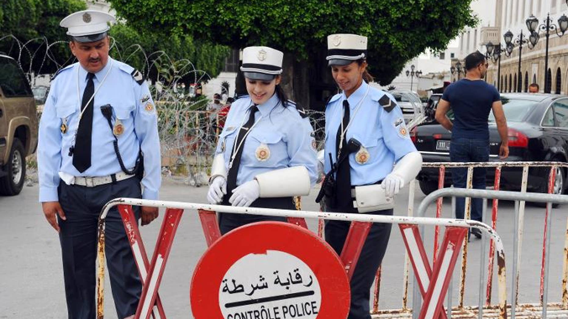 Tunisian police officers stand guard in the Kasbah neighborhood in Tunis, on June 14, 2012.