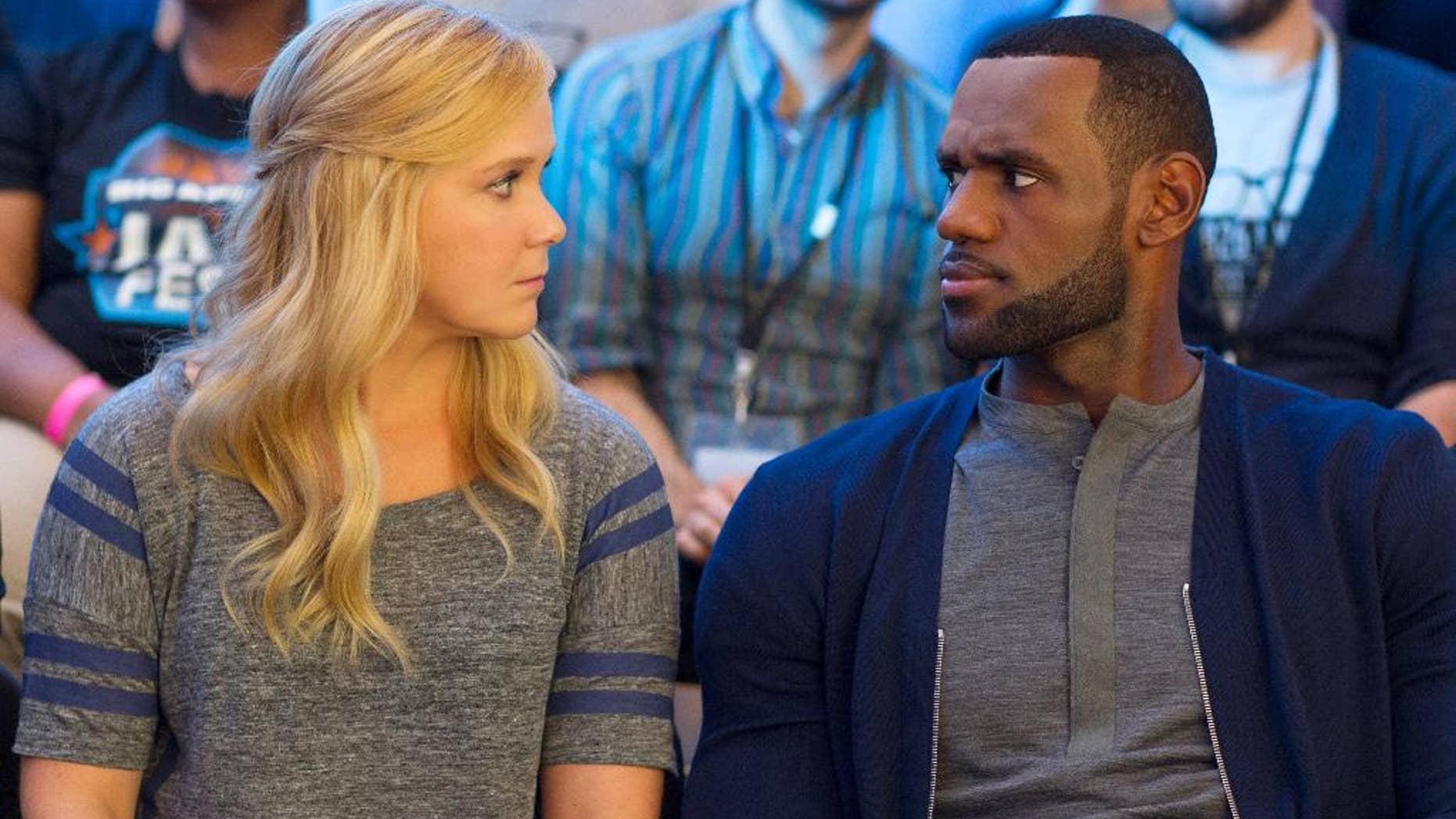 Amy Schumer, left, and LeBron James in a scene from the comedy, "Trainwreck."
