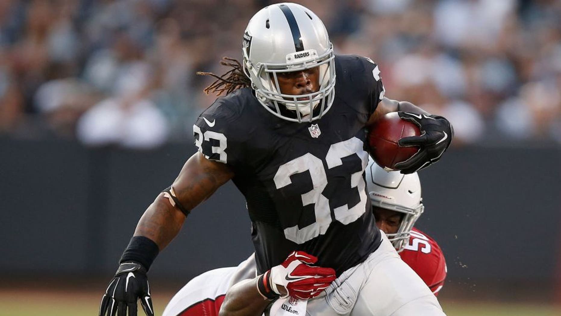 OAKLAND, CA - AUGUST 30: Trent Richardson #33 of the Oakland Raiders is tackled by Gabe Martin #50 of the Arizona Cardinals at O.co Coliseum on August 30, 2015 in Oakland, California. (Photo by Ezra Shaw/Getty Images)