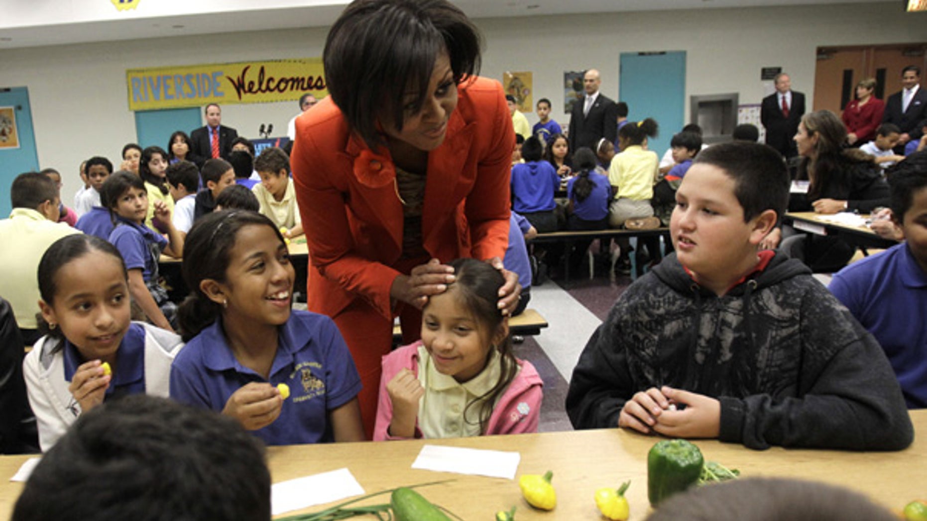 Nov. 22: First lady Michelle Obama talks with students as they taste fresh vegetables at an elementary school in Miami.