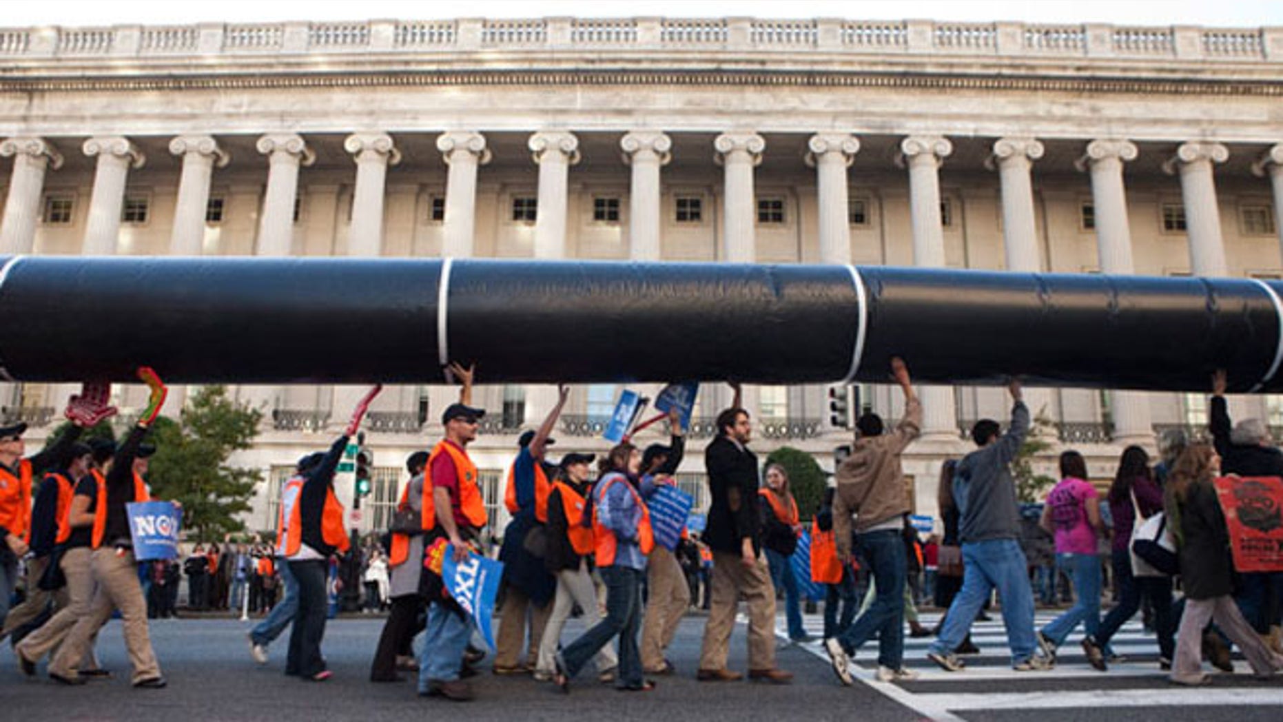 Nov. 6, 2011: Demonstrators carry a mock pipeline during an anti-Keystone rally in front of the White House in Washington.