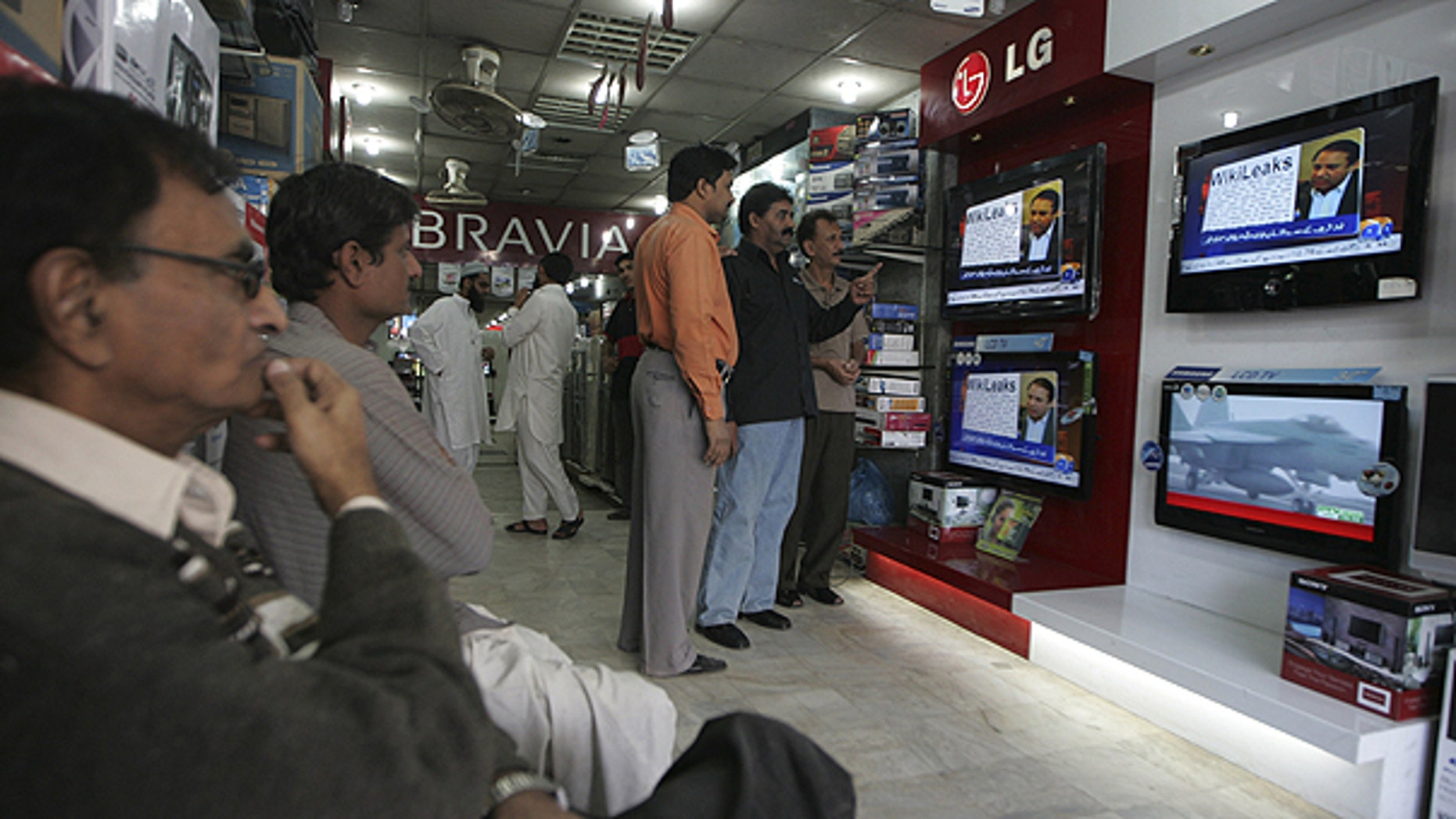 Dec. 2: People watch Wikileaks memos at an electronic shop in Karachi, Pakistan.