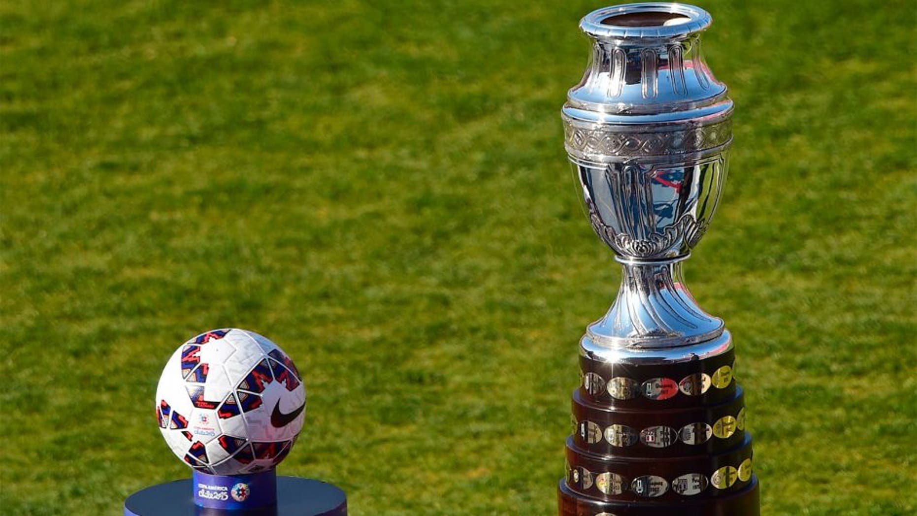 View of the Copa America trophy (R) and the football before the start of the 2015 Copa America football championship final Argentina vs Chile, in Santiago, Chile, on July 4, 2015. AFP PHOTO / MARTIN BERNETTI (Photo credit should read MARTIN BERNETTI/AFP/Getty Images)