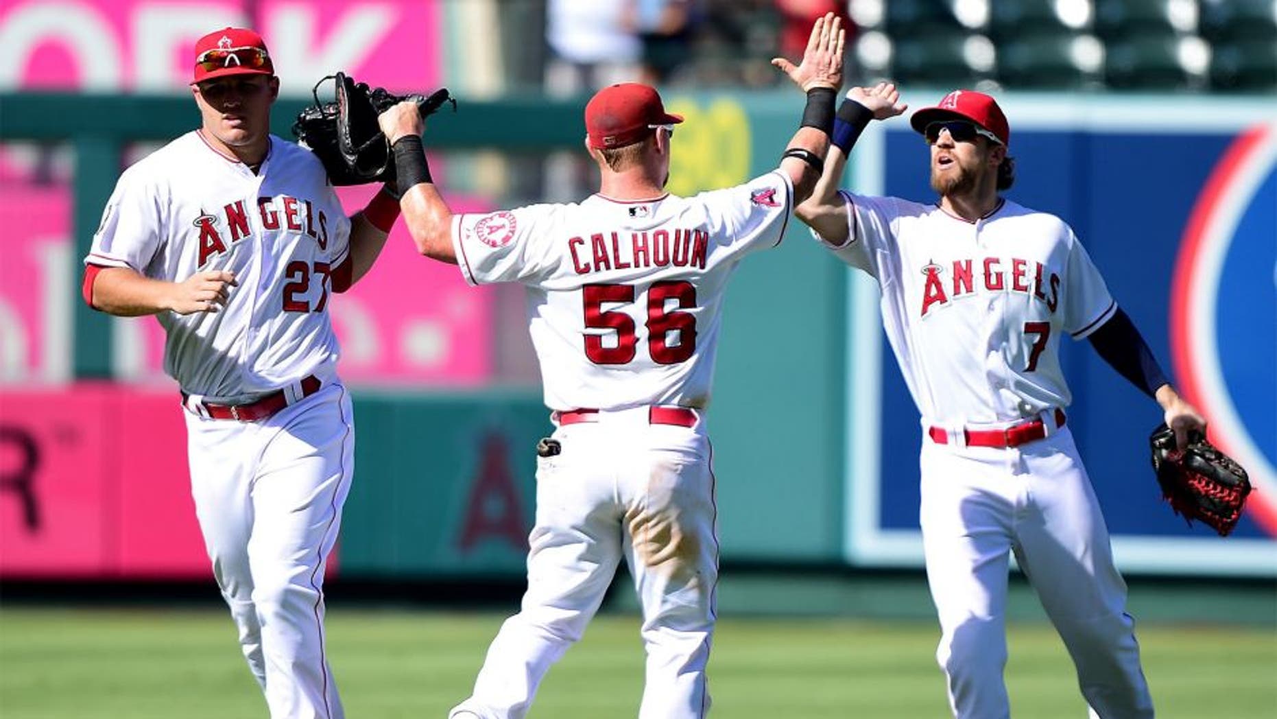 ANAHEIM, CA - SEPTEMBER 27: Kole Calhoun #56 of the Los Angeles Angels celebrates a 3-2 win over the Seattle Mariners with Mike Trout #27 and Collin Cowgill #7 at Angel Stadium of Anaheim on September 27, 2015 in Anaheim, California. (Photo by Harry How/Getty Images)