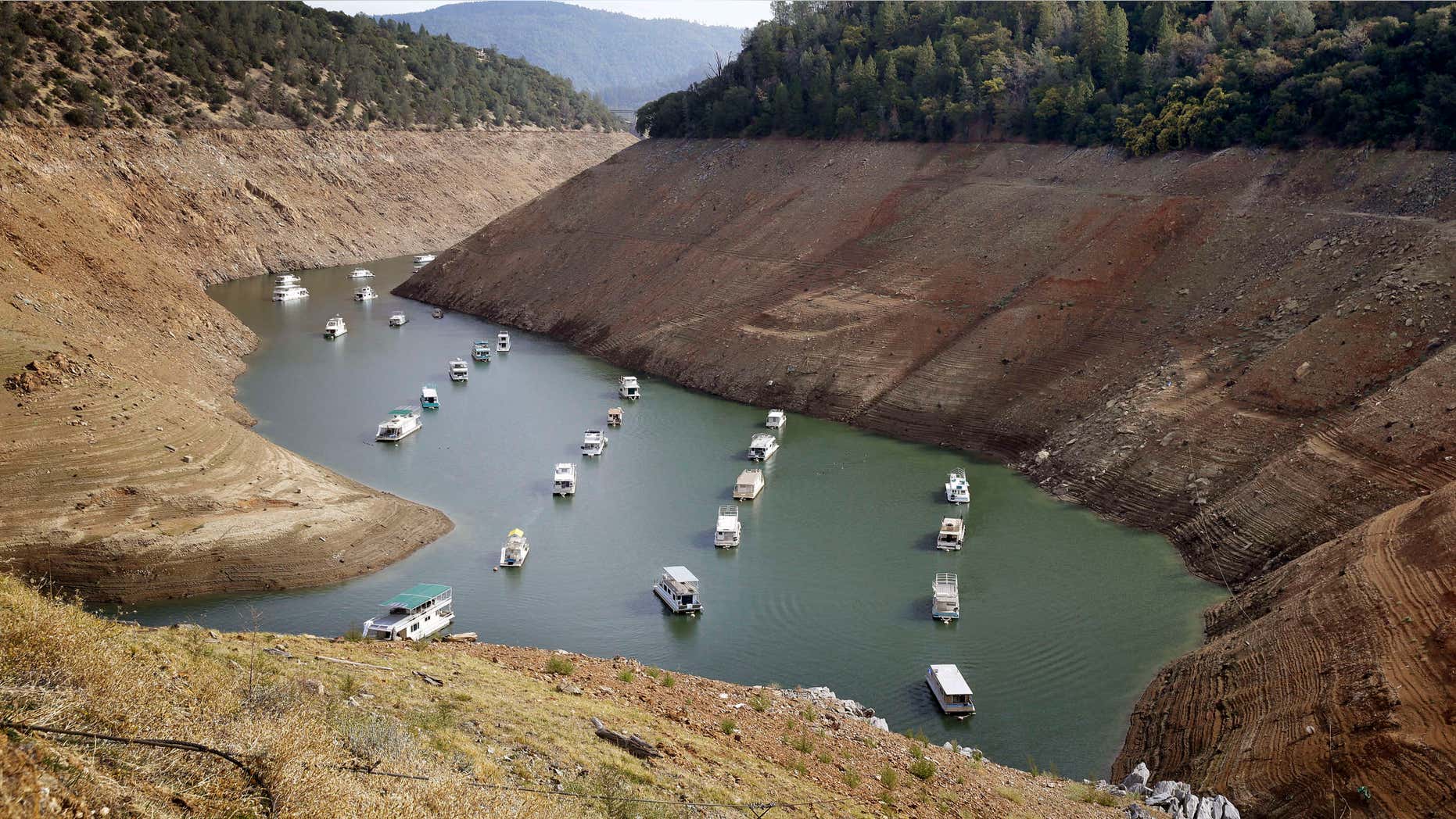 FILE - In this Thursday, Oct. 30, 2014, file photo, houseboats float in the drought-lowered waters of Oroville Lake near Oroville, Calif.