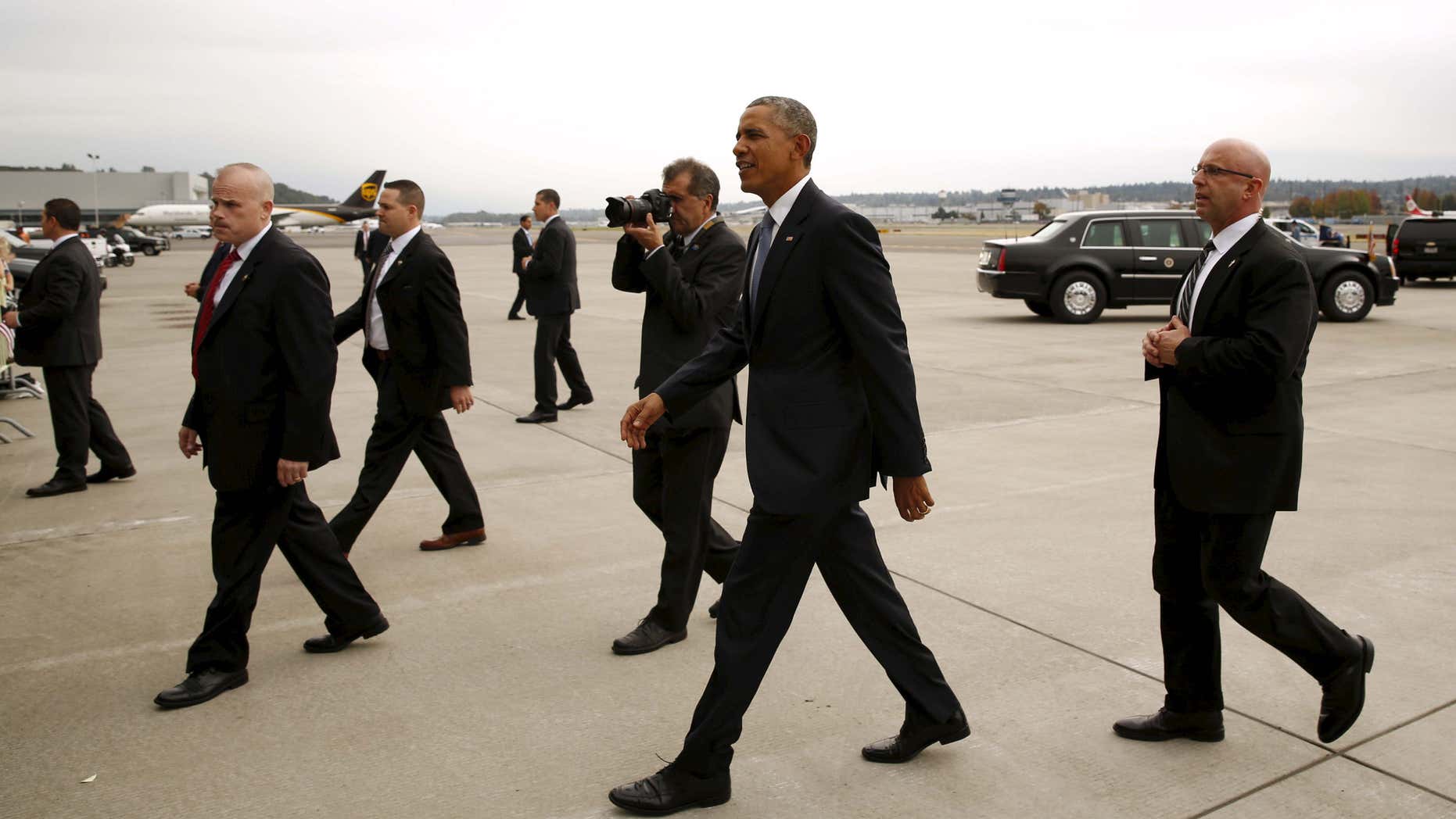 Oct. 9, 2015: Members of the Secret Service escort President Barack Obama to greet supporters upon his arrival in Seattle, Washington.