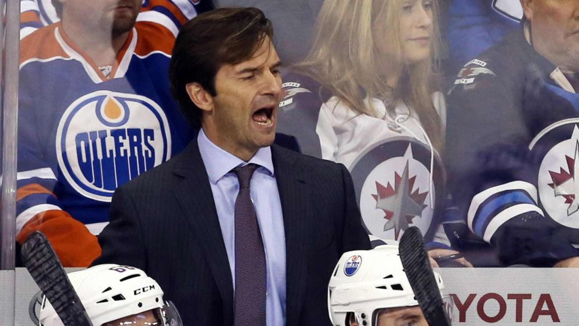 Dec 3, 2014; Winnipeg, Manitoba, CAN; Edmonton Oilers head coach Dallas Eakins reacts during the second period against the Winnipeg Jets at MTS Centre. Mandatory Credit: Bruce Fedyck-USA TODAY Sports