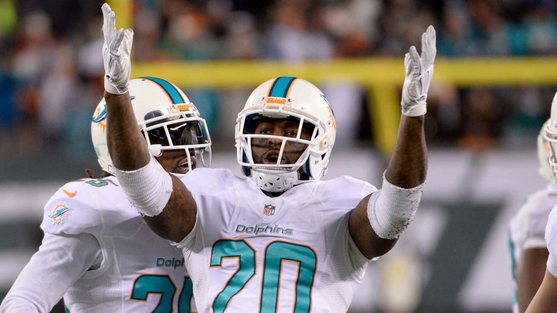 Dec 1, 2014; East Rutherford, NJ, USA; Miami Dolphins strong safety Reshad Jones (20) celebrates after making an interception with under a minute left against the New York Jets at MetLife Stadium. Mandatory Credit: Robert Deutsch-USA TODAY Sports
