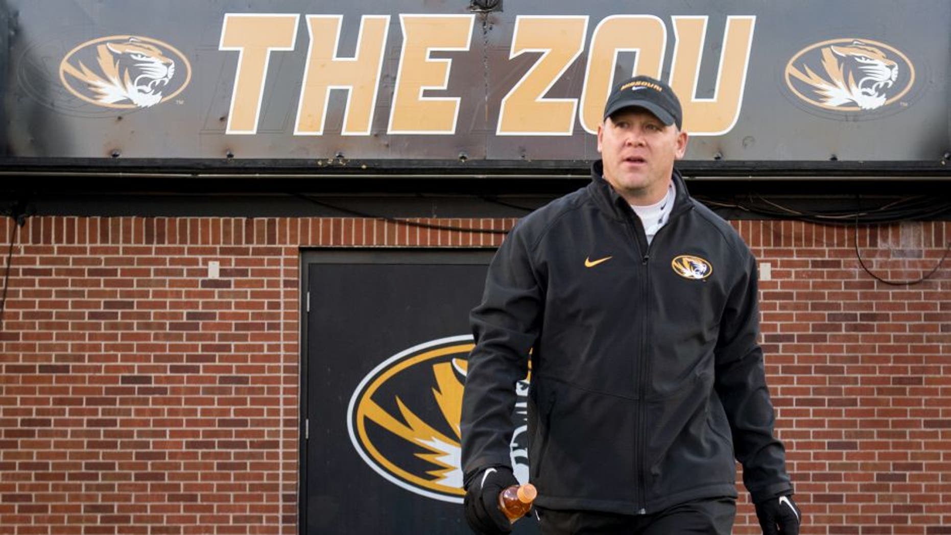 FILE - In this Saturday, Nov. 21, 2015 file photo, Missouri defensive coordinator Barry Odom walks on the field before the start of their NCAA college football game against Tennessee in Columbia, Mo. Missouri has promoted defensive coordinator Barry Odom to replace the retiring Gary Pinkel as head coach. The school said in a release Thursday night, Dec. 3, 2015 that Odom had agreed in principle to a five-year deal that will need to be approved by the schoolâs board of curators next week.(AP Photo/L.G. Patterson, File)