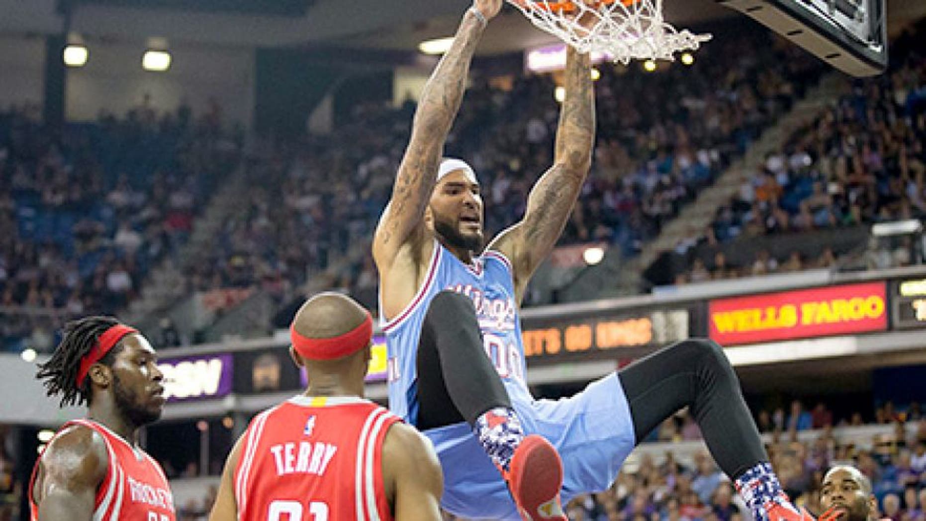 Nov 6, 2015; Sacramento, CA, USA; Sacramento Kings center Willie Cauley-Stein (00) reacts above Houston Rockets forward Montrezl Harrell (35), guard Jason Terry (31) and guard Marcus Thornton (10) after a dunk during the third quarter at Sleep Train Arena. The Houston Rockets defeated the Sacramento Kings 116-110. Mandatory Credit: Kelley L Cox-USA TODAY Sports