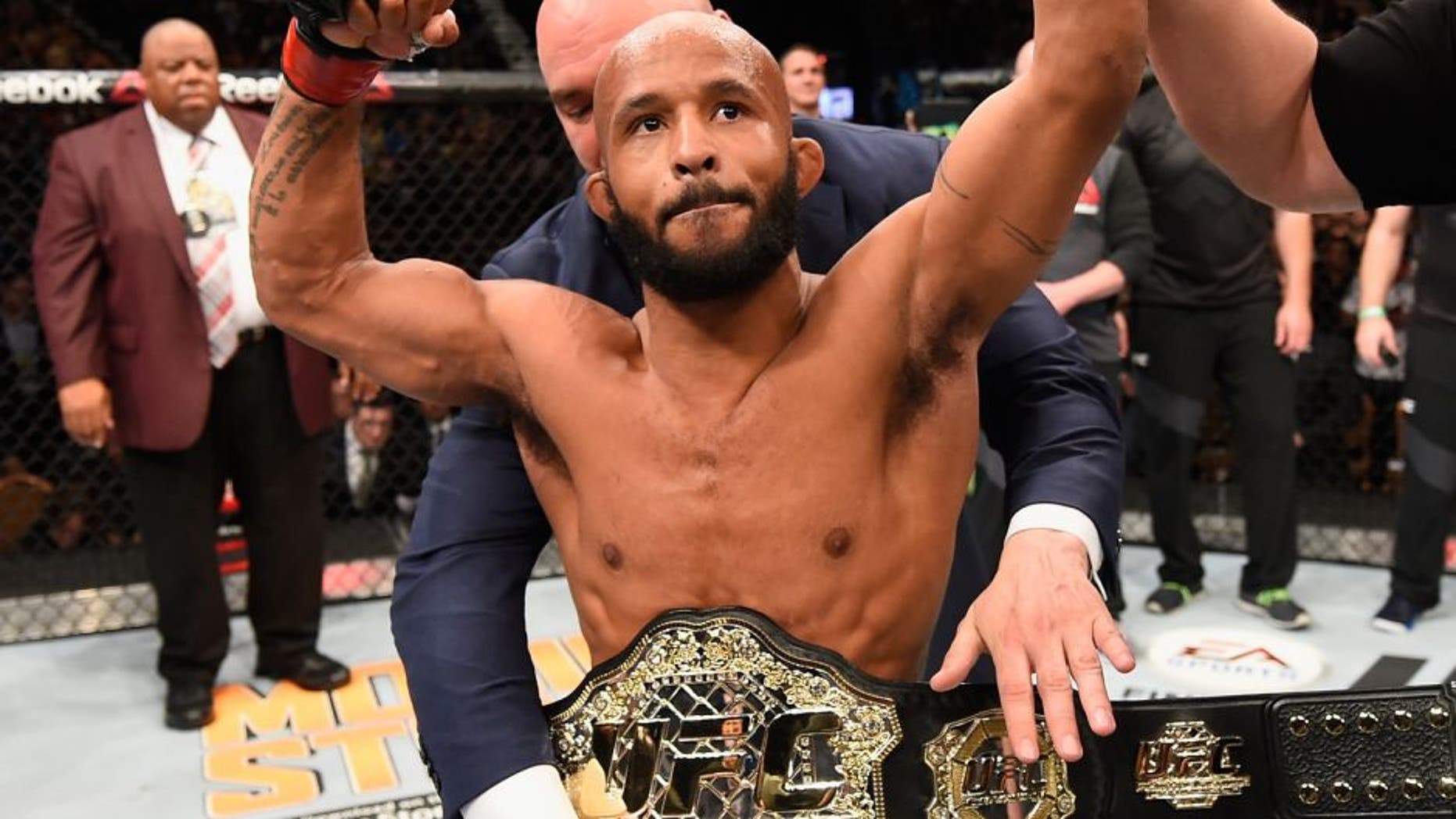LAS VEGAS, NV - APRIL 23: Demetrious Johnson celebrates his TKO victory over Henry Cejudo in their flyweight championship bout during the UFC 197 event inside MGM Grand Garden Arena on April 23, 2016 in Las Vegas, Nevada. (Photo by Josh Hedges/Zuffa LLC/Zuffa LLC via Getty Images)