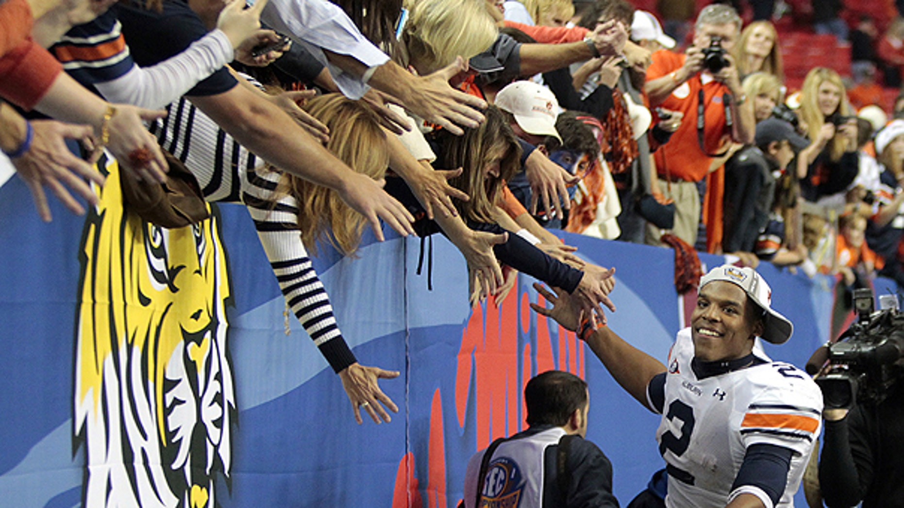 Dec. 4: Auburn quarterback Cameron Newton (2) celebrates with the fans after defeating South Carolina, 56-17, during the Southeastern Conference championship NCAA college football game in Atlanta.