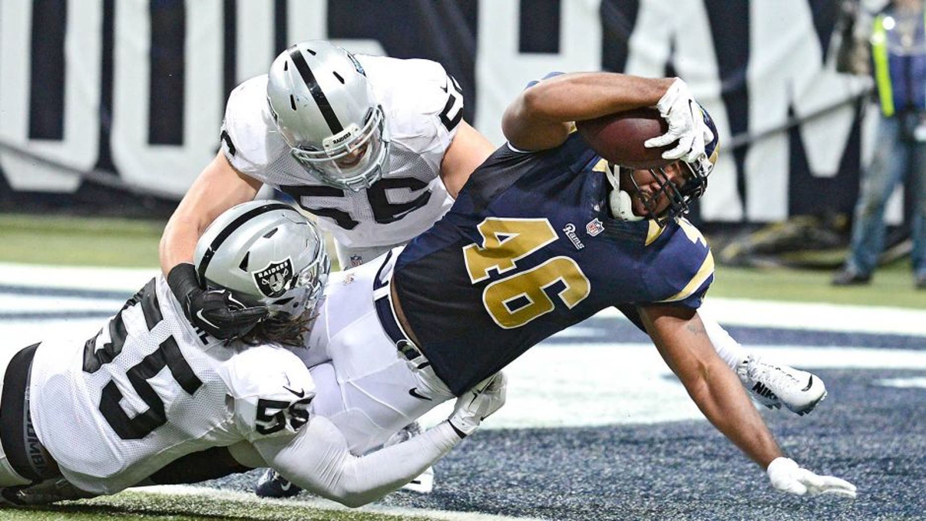 Nov 30, 2014; St. Louis, MO, USA; St. Louis Rams tight end Cory Harkey (46) is tackled into the end zone by Oakland Raiders outside linebacker Sio Moore (55) for a four yard touchdown during the first half at the Edward Jones Dome. Mandatory Credit: Jeff Curry-USA TODAY Sports