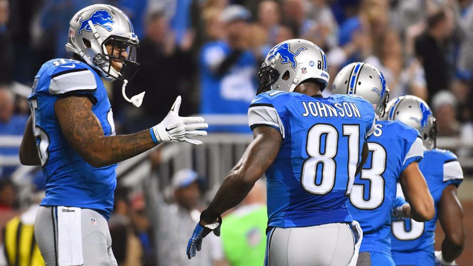Dec 3, 2015; Detroit, MI, USA; Detroit Lions tight end Eric Ebron (85) celebrates his touchdown with wide receiver Calvin Johnson (81) during the first quarter against the Green Bay Packers at Ford Field. Mandatory Credit: Tim Fuller-USA TODAY Sports